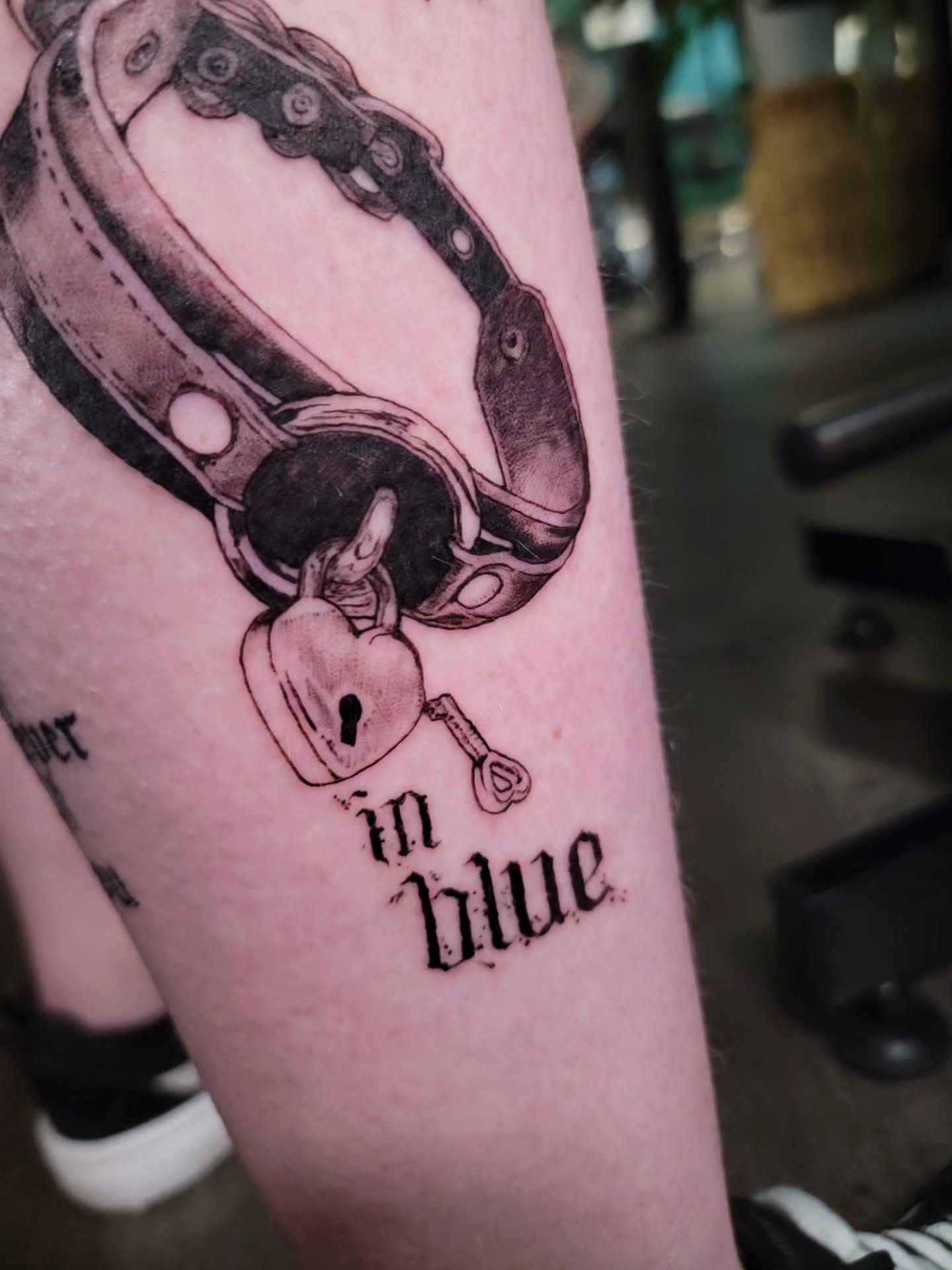 Handcuffs and key black and grey tattoo on the forearm by Nathan Harkins-Oberbeck