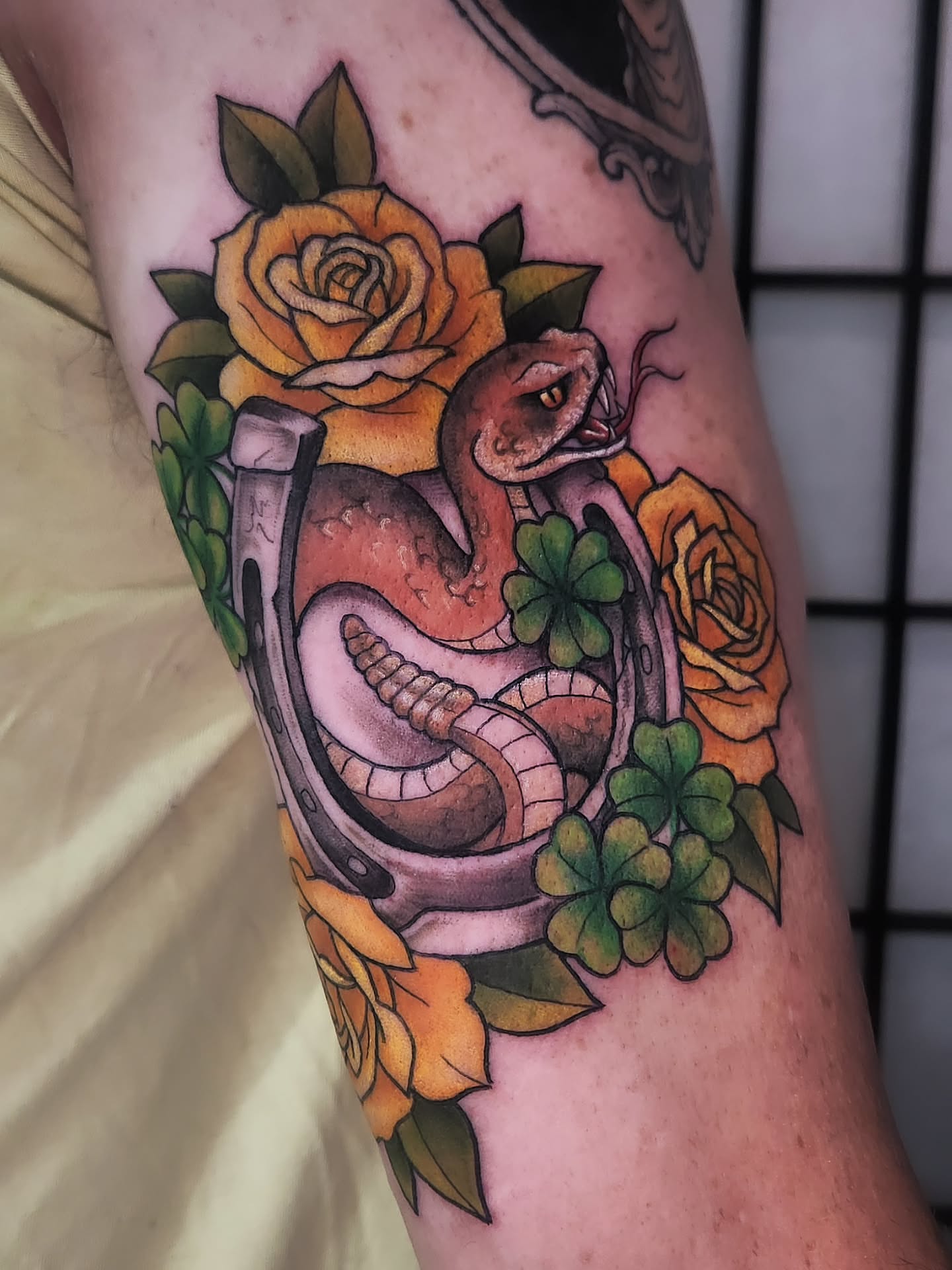 Snake and roses American traditional tattoo on the forearm by Amanda Boyd - Duh!