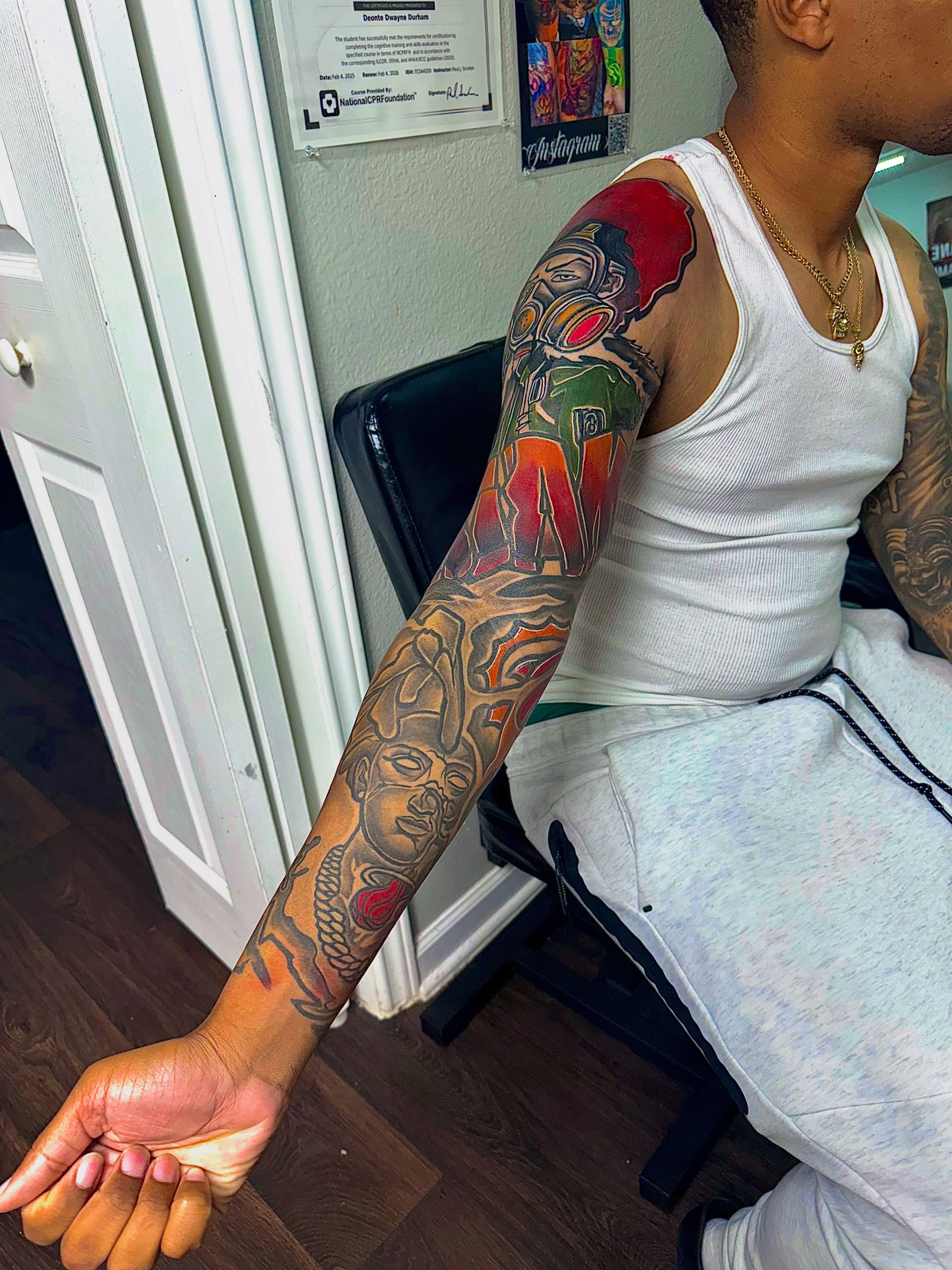 Abstract design new school tattoo on the upper arm by Deonte Dwayne Durham