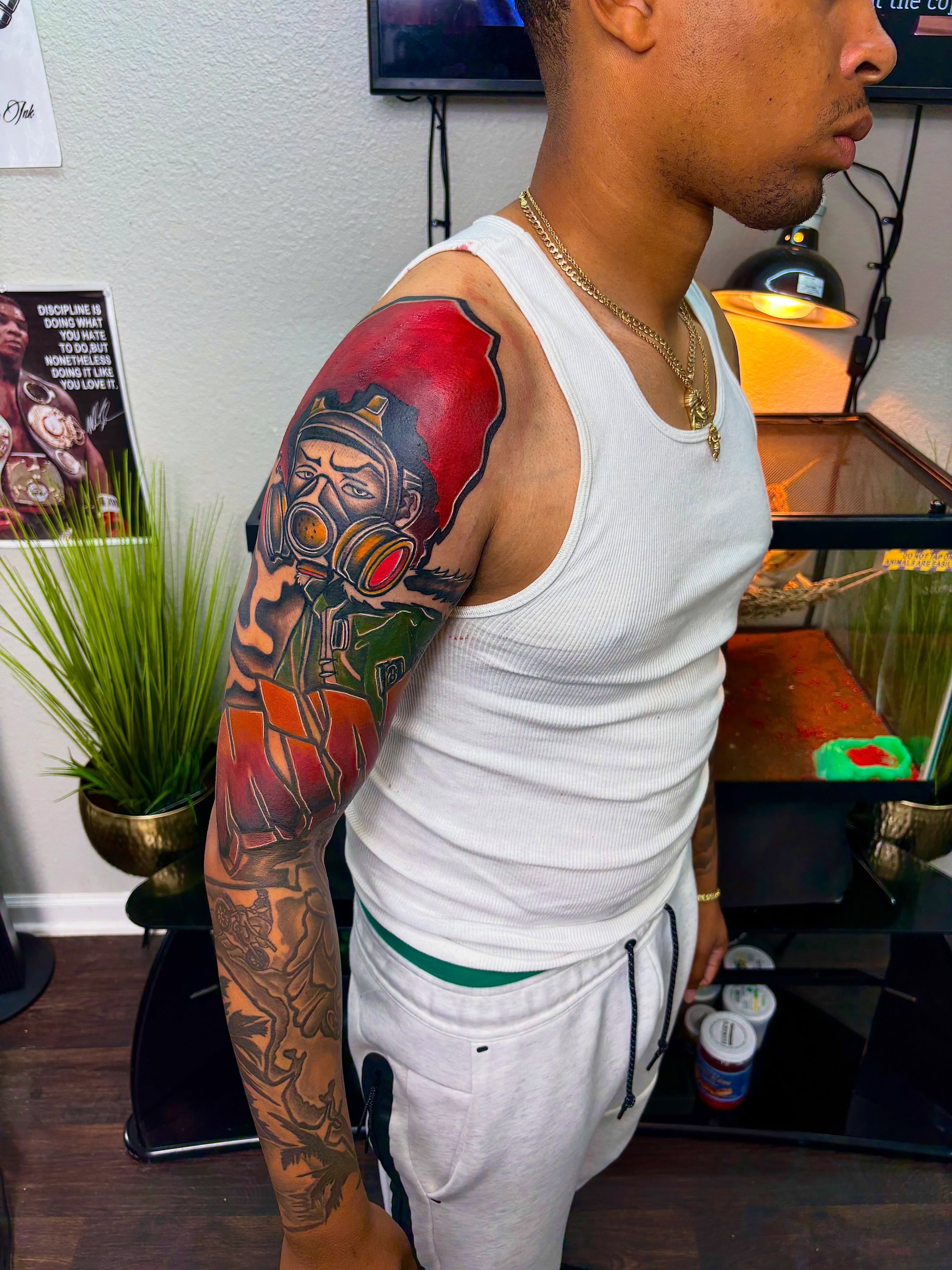 Gas mask American traditional tattoo on the upper arm by Deonte Dwayne Durham