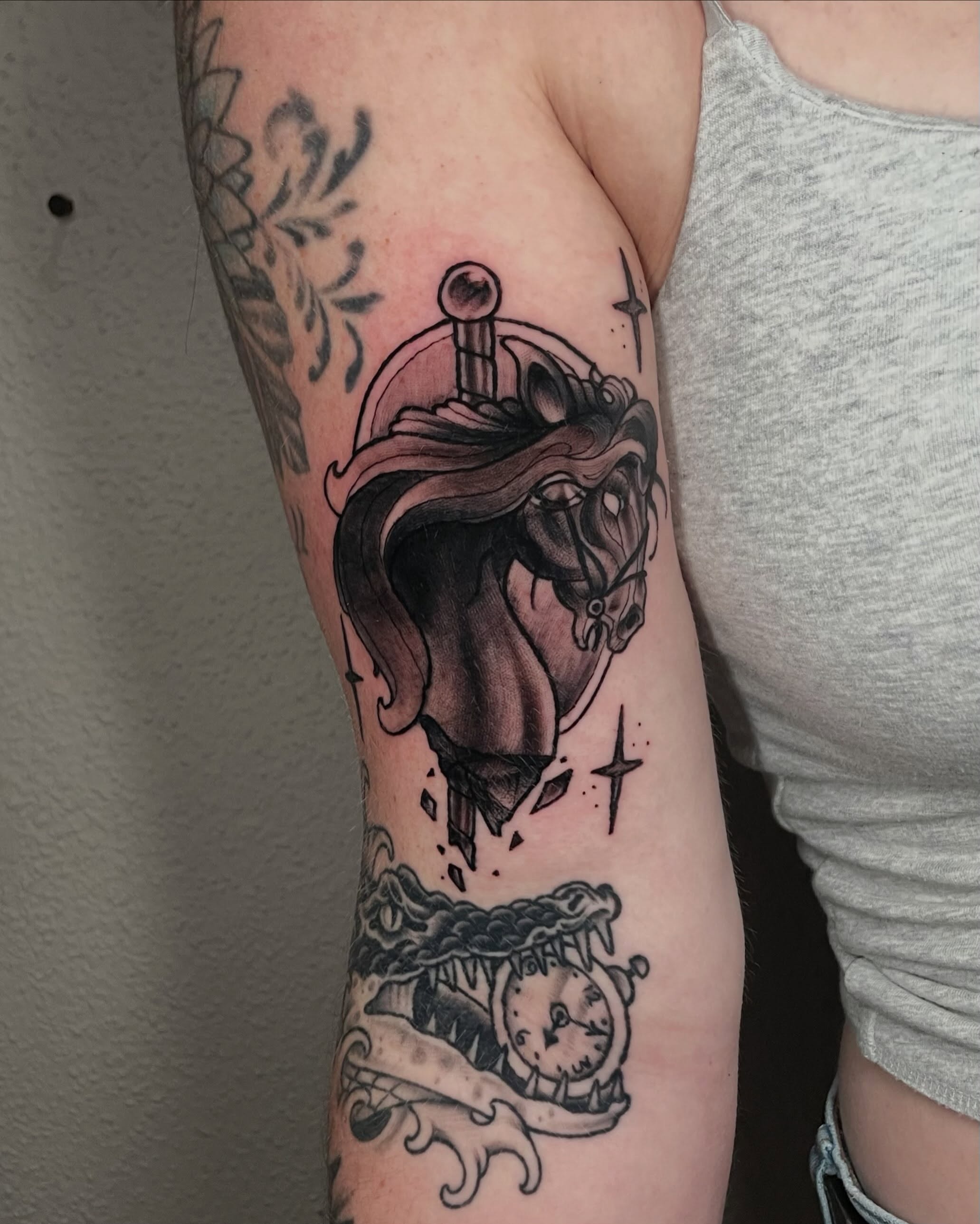 Horse head with sword realism tattoo on the forearm by Alex Larsen