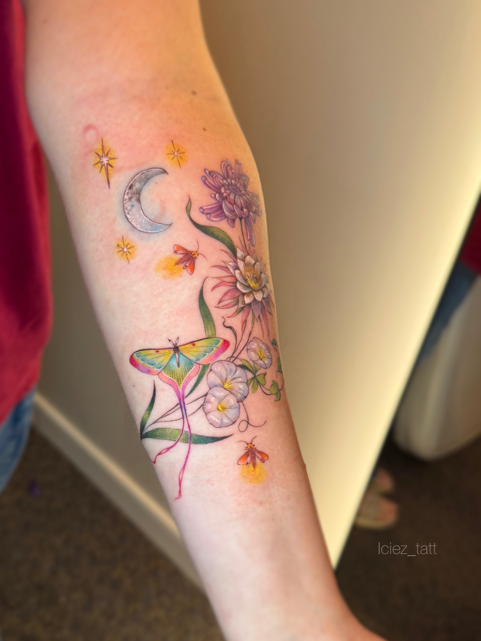 Moon, flowers, butterfly, insects watercolor tattoo on the forearm by Iciez