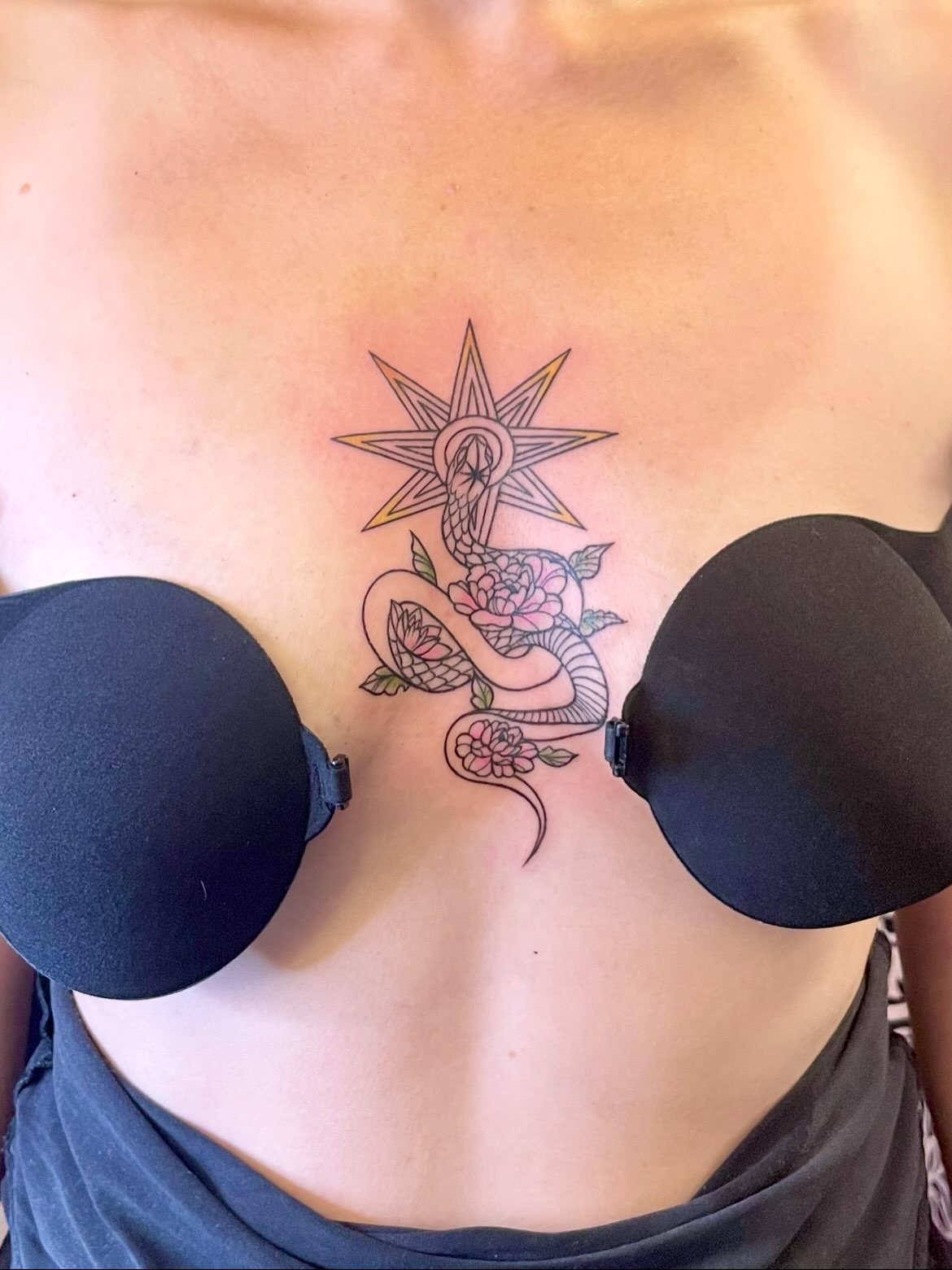 Snake and peony neo-traditional tattoo on the chest by Grace derby tattooist, Derby