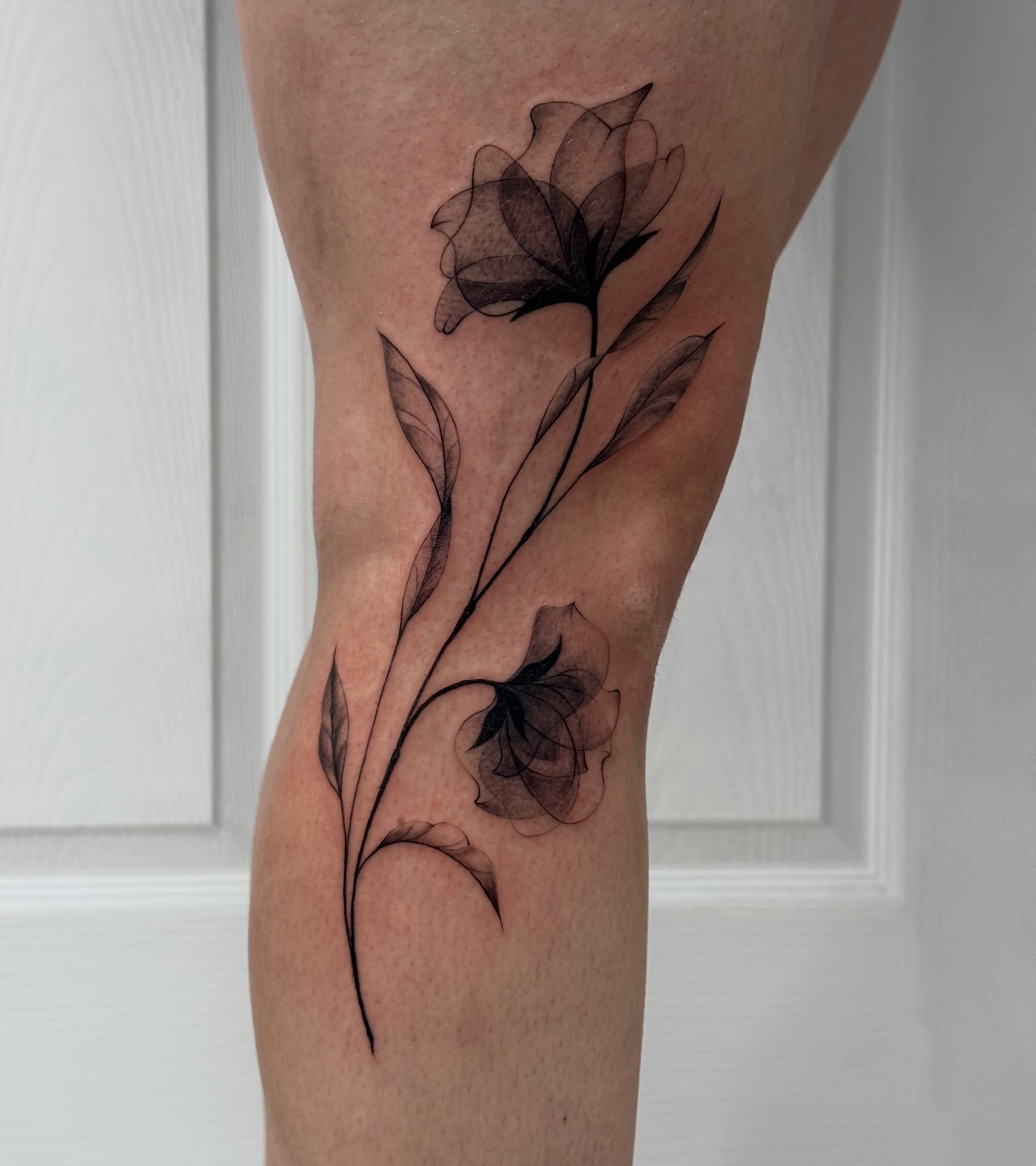 Flowers black and grey tattoo on the leg by Lacee-Beth Finch