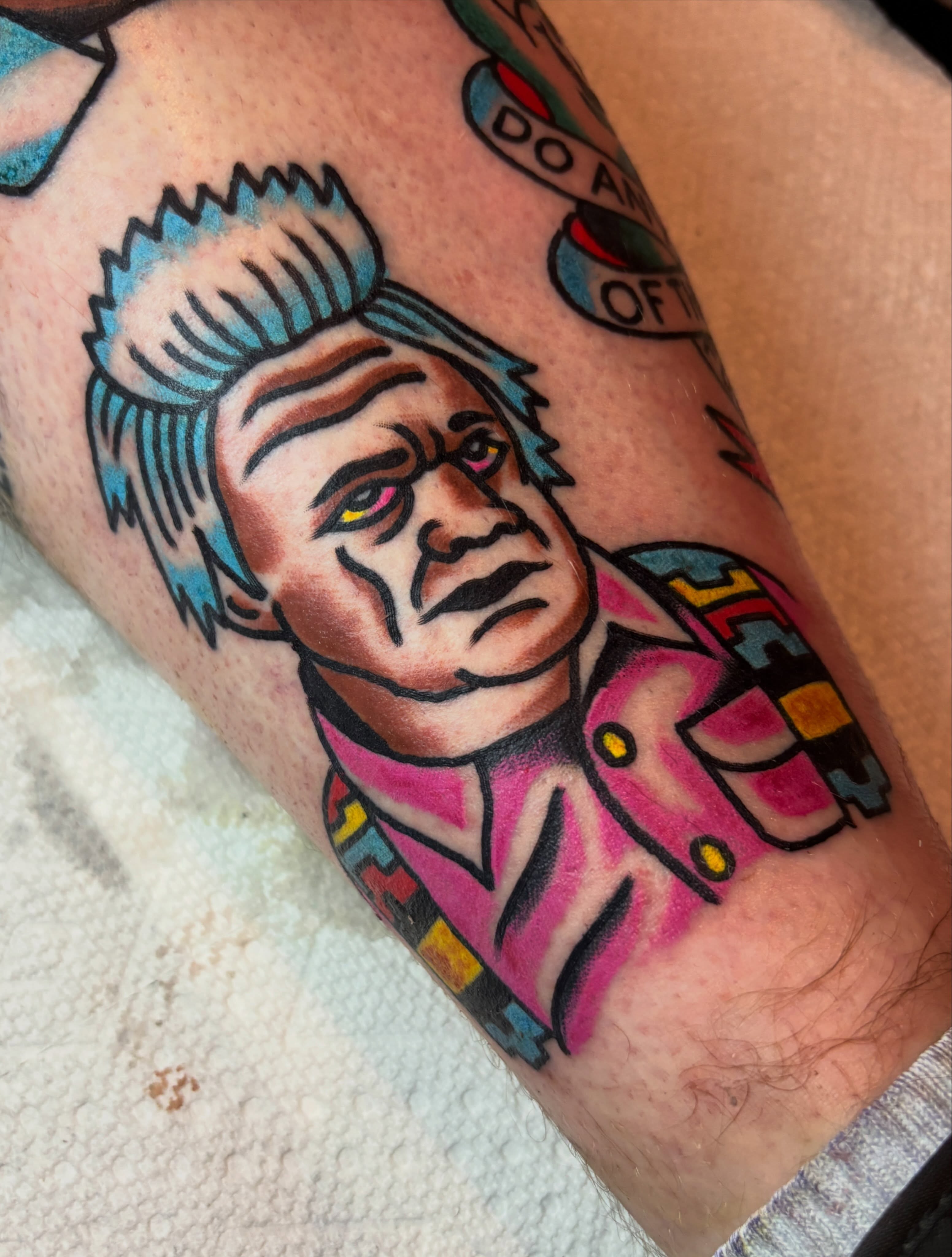 Mohawked character American traditional tattoo on the forearm by Mitch Ashpaugh