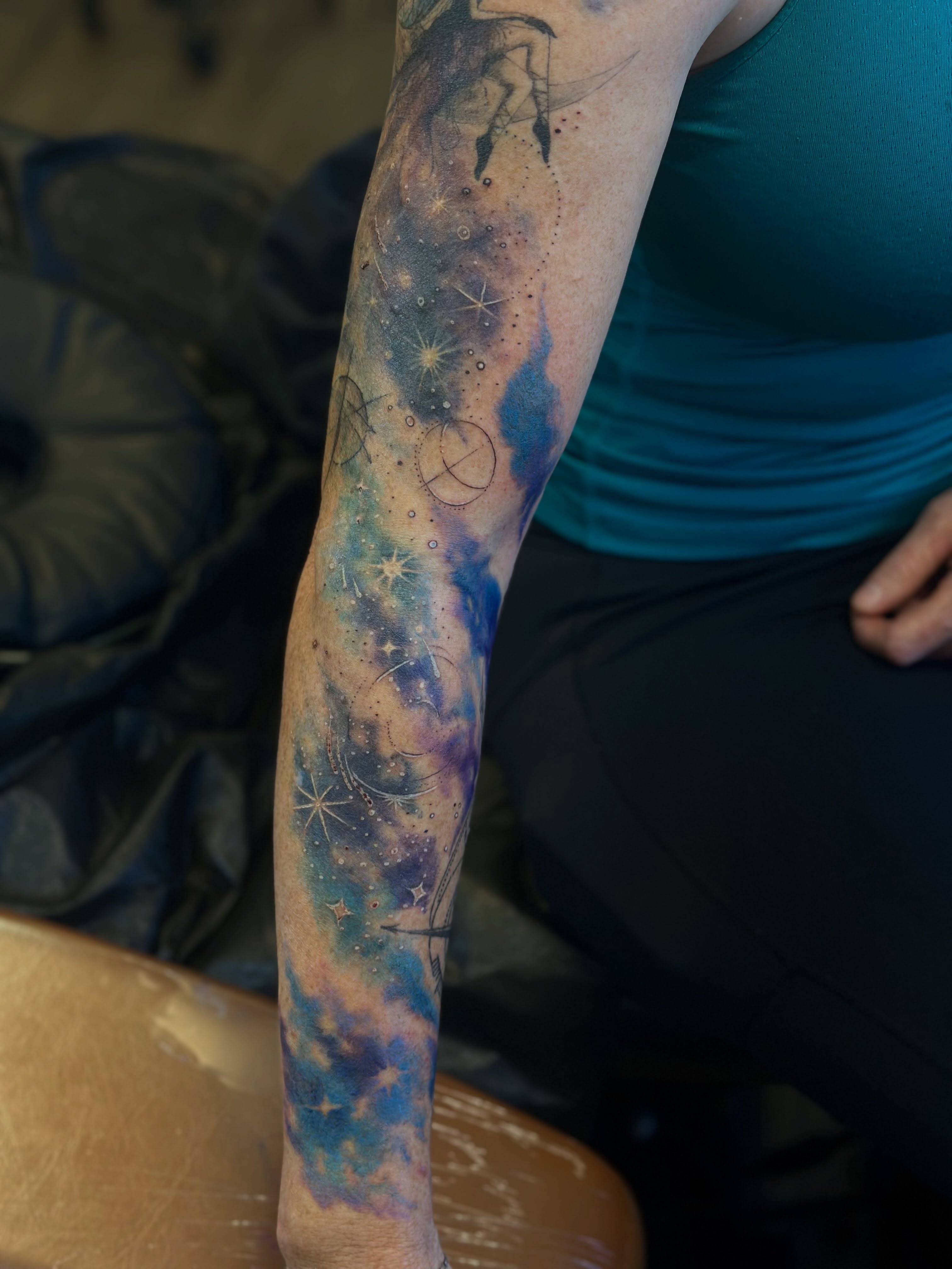 Galaxy dotwork tattoo on the forearm by Teddi Bird