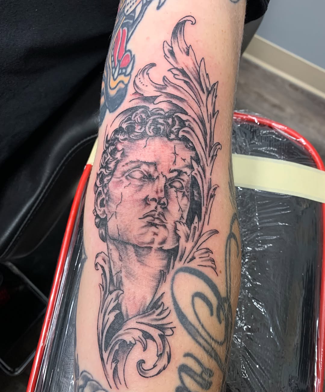 Statue head realism tattoo on the forearm by @goat76