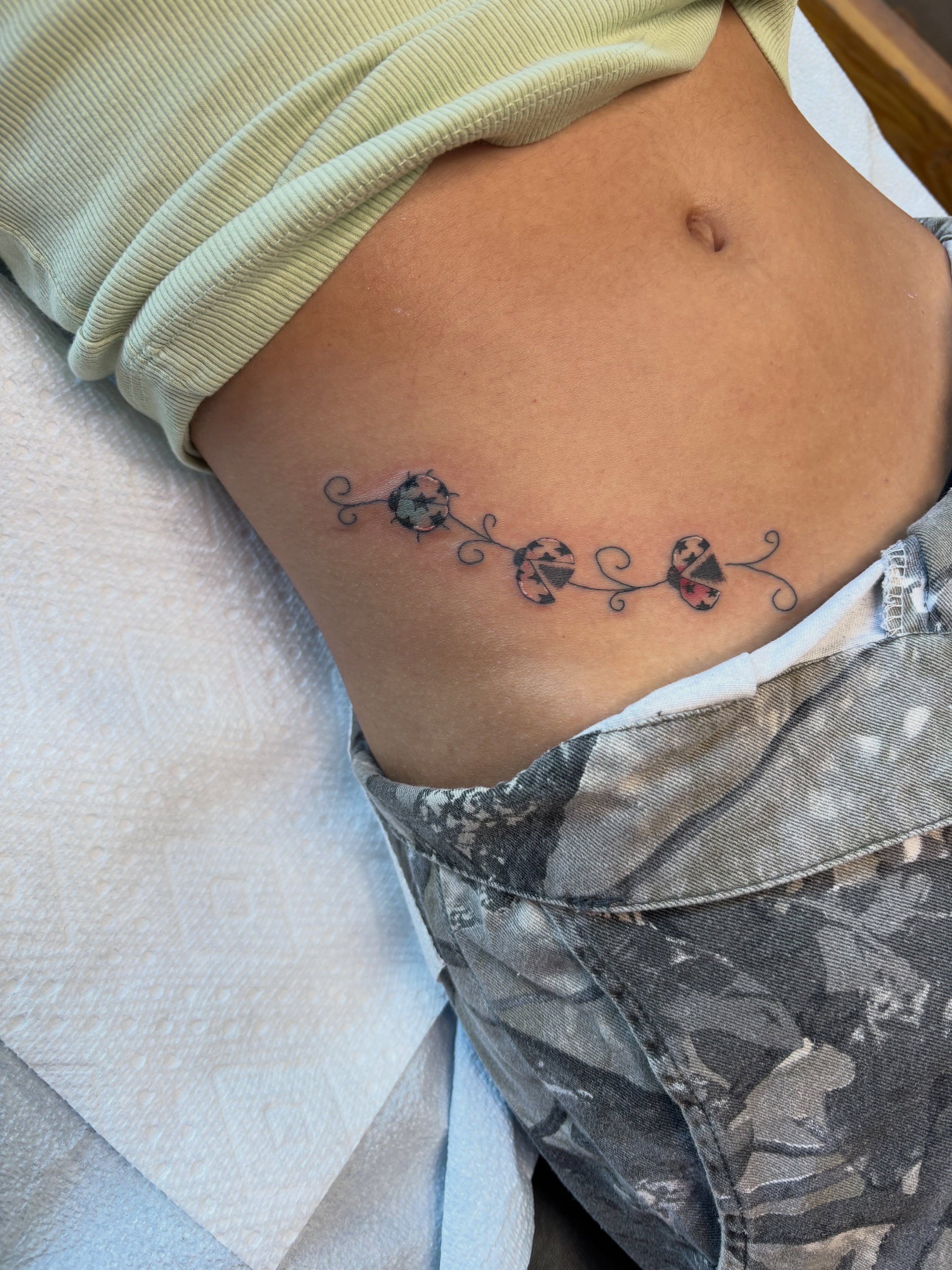 Three stylized flowers dotwork tattoo on the ribs by Samantha💋🥀