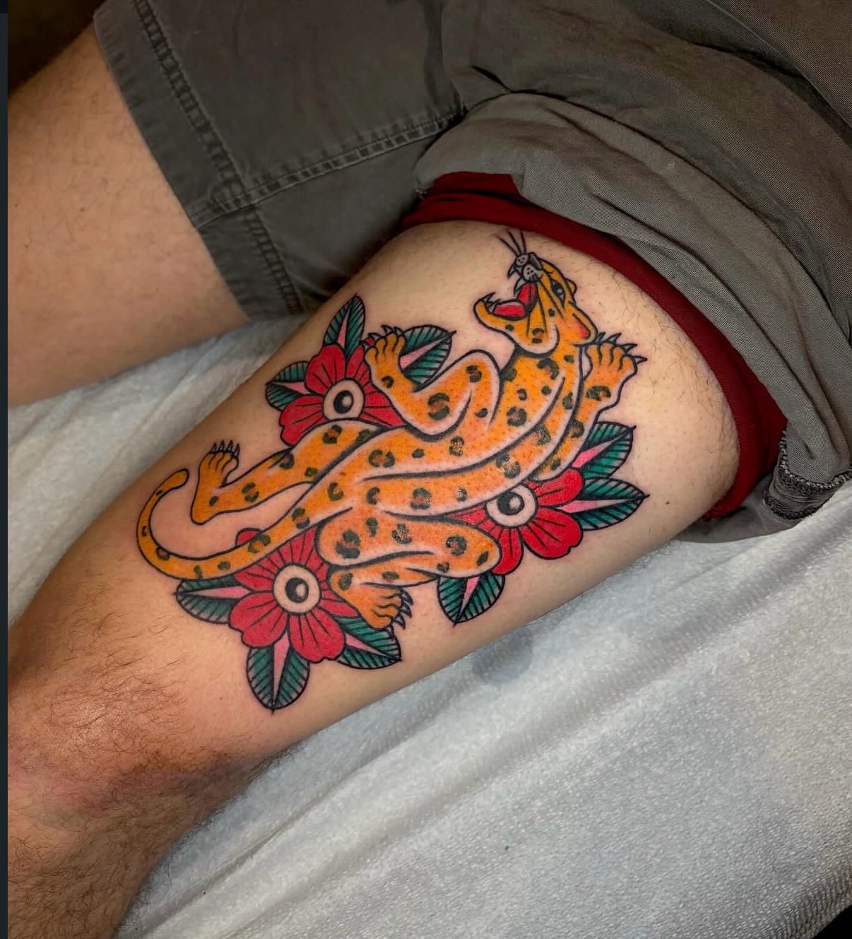 Leopard and flowers American traditional tattoo on the thigh by Danelle ✶ Nashville Tattooer