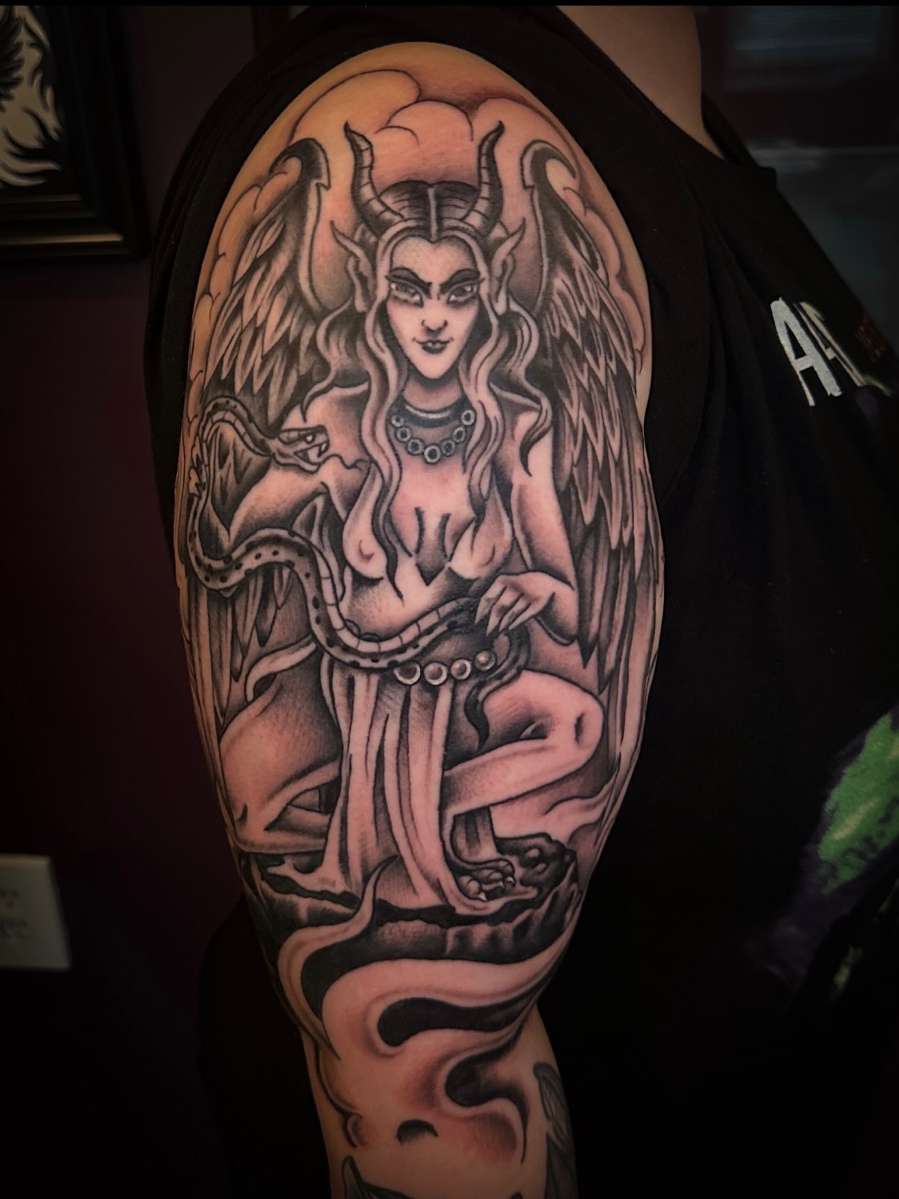 Winged female figure realism tattoo on the upper arm by Stacey Colangelo