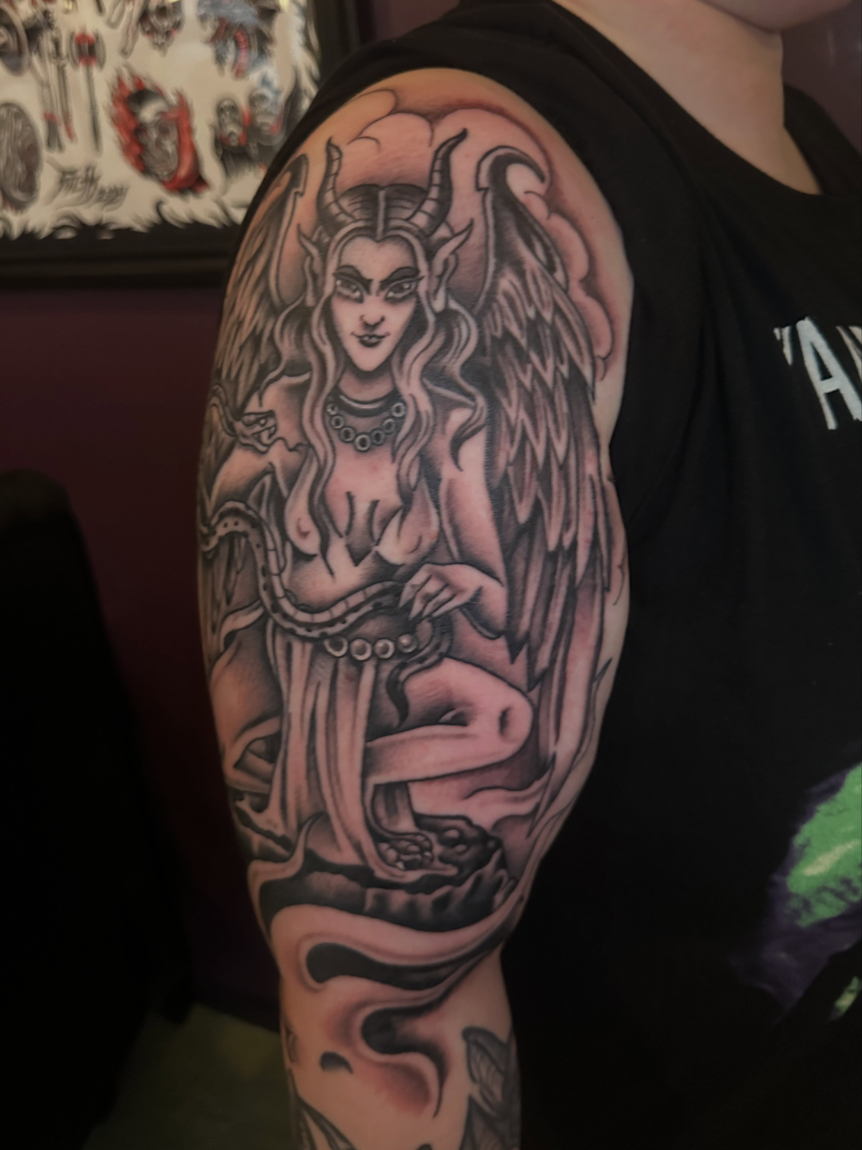 Winged woman neo-traditional tattoo on the upper arm by Stacey Colangelo