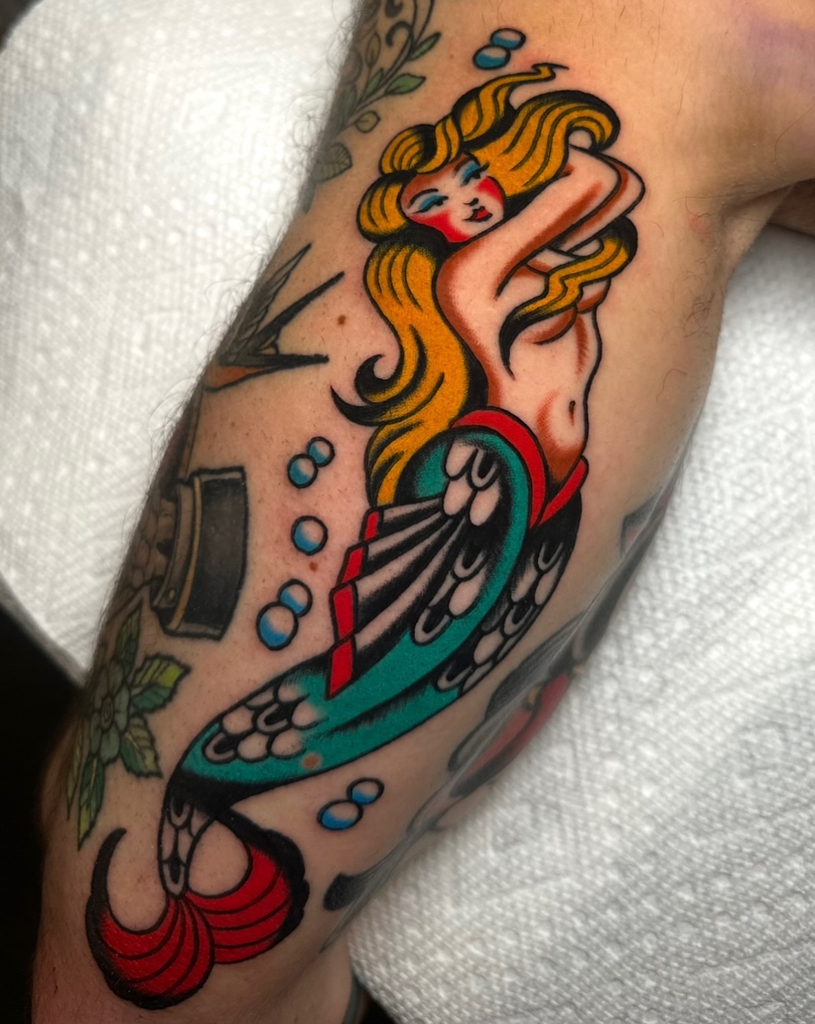 Mermaid American traditional tattoo on the forearm by Zahra Niedermann