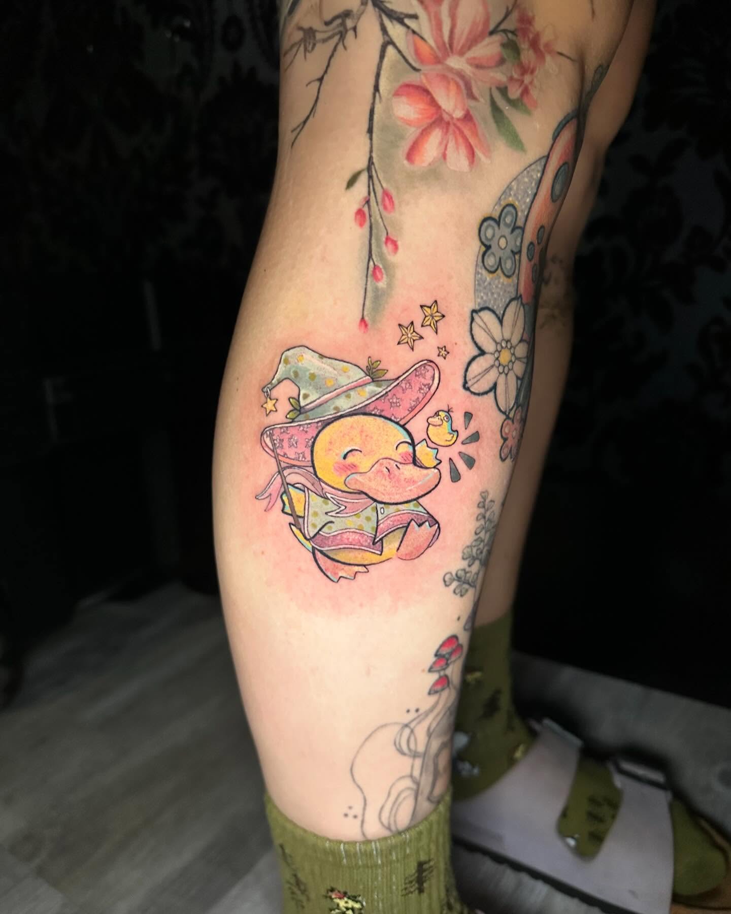 Duckling in hat new school tattoo on the forearm by Cassandra Rasper-Beard