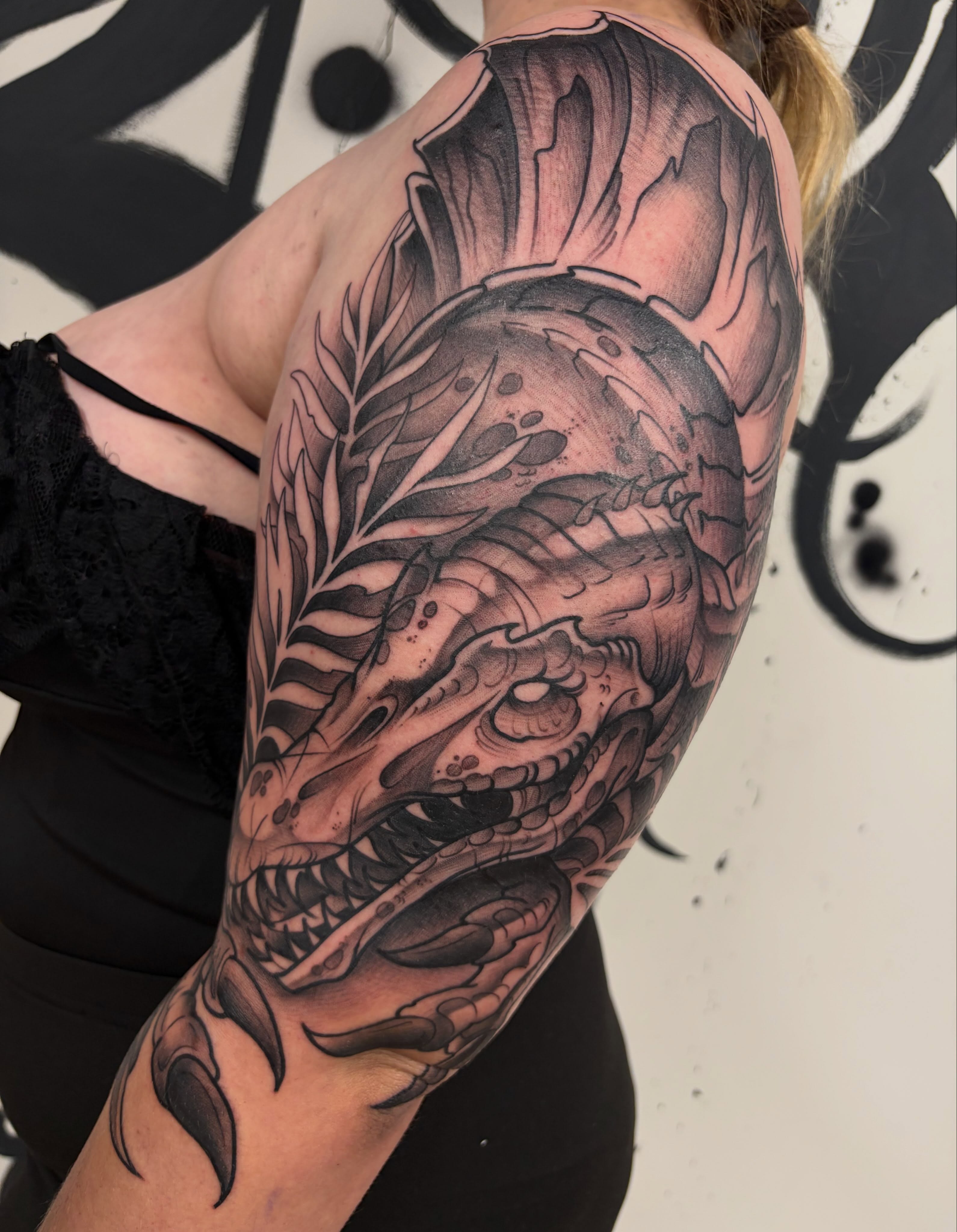 Dragon head realism tattoo on the upper arm by Kayla Fay, Baton Rouge, Louisiana