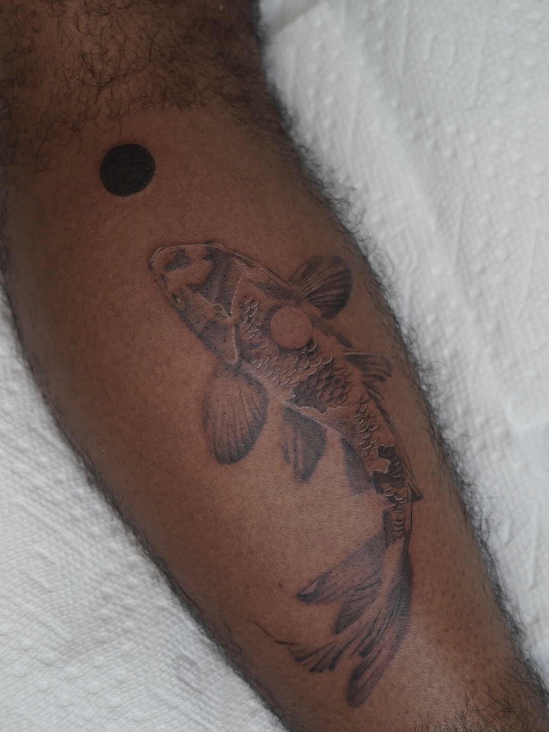 Fish black and grey tattoo on the forearm by Josh Infante