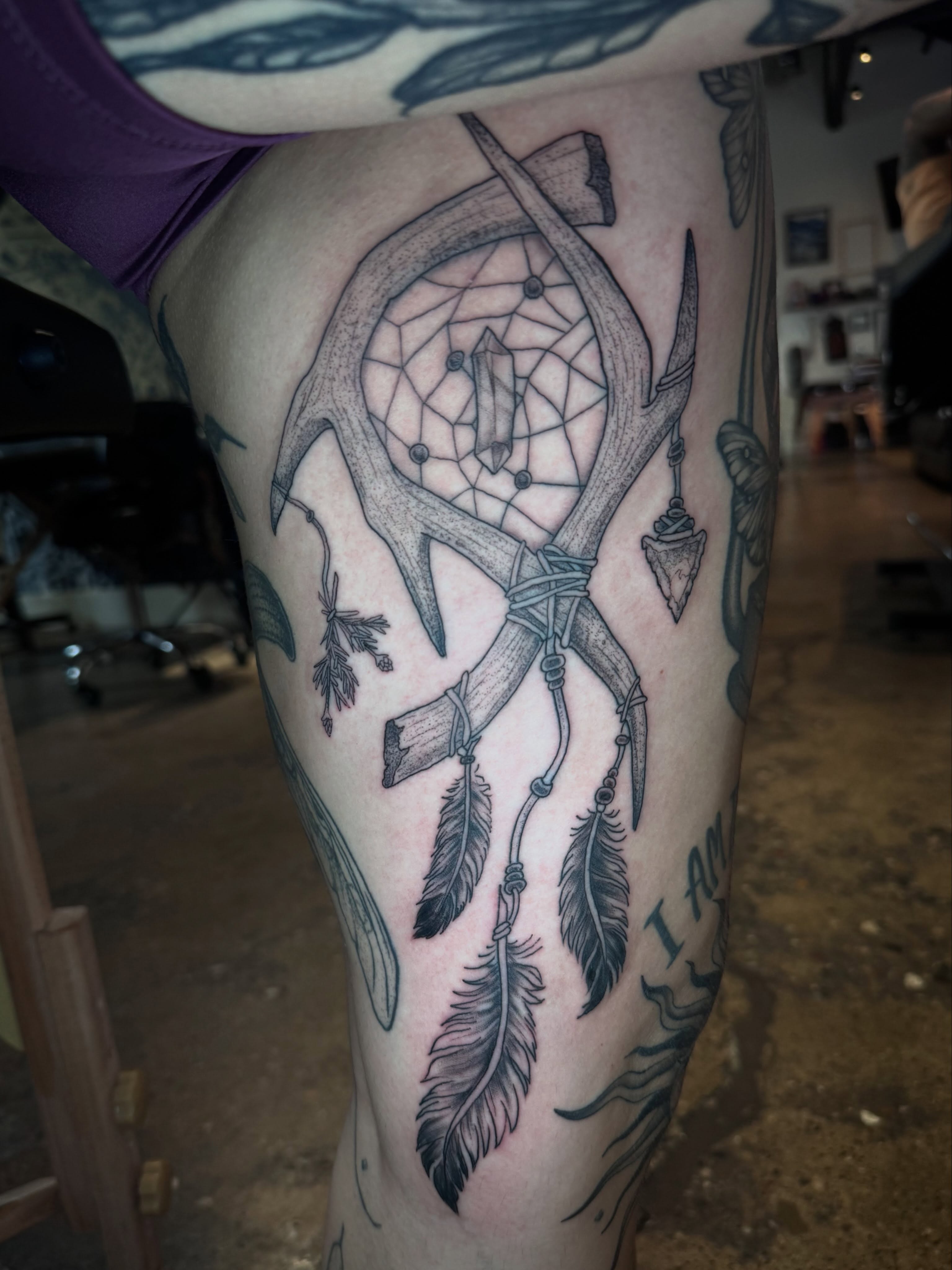 Deer antler dreamcatcher black and grey tattoo on the thigh by Gabrielle Mack