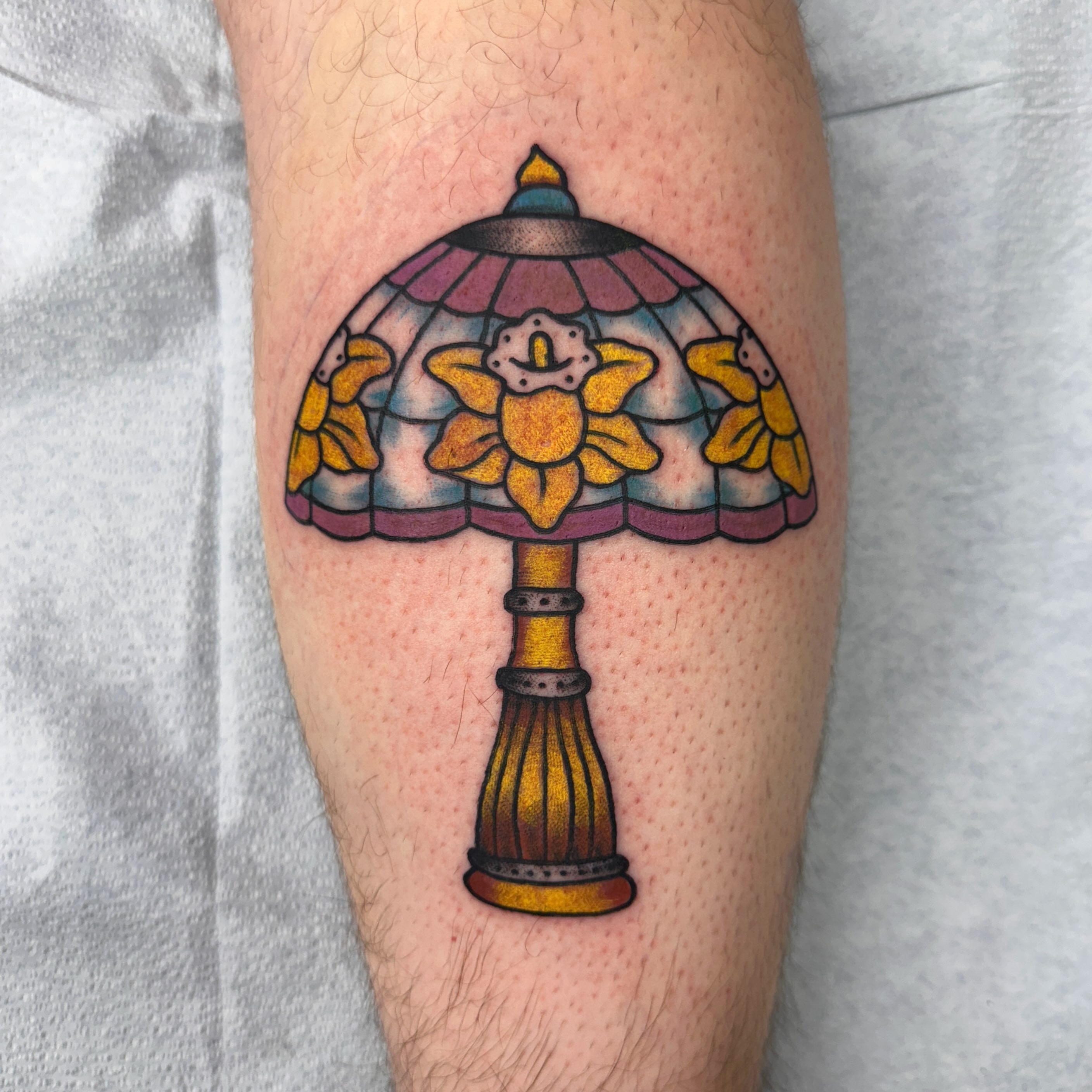 Stained glass lamp new school tattoo on the forearm by Fil Ponte