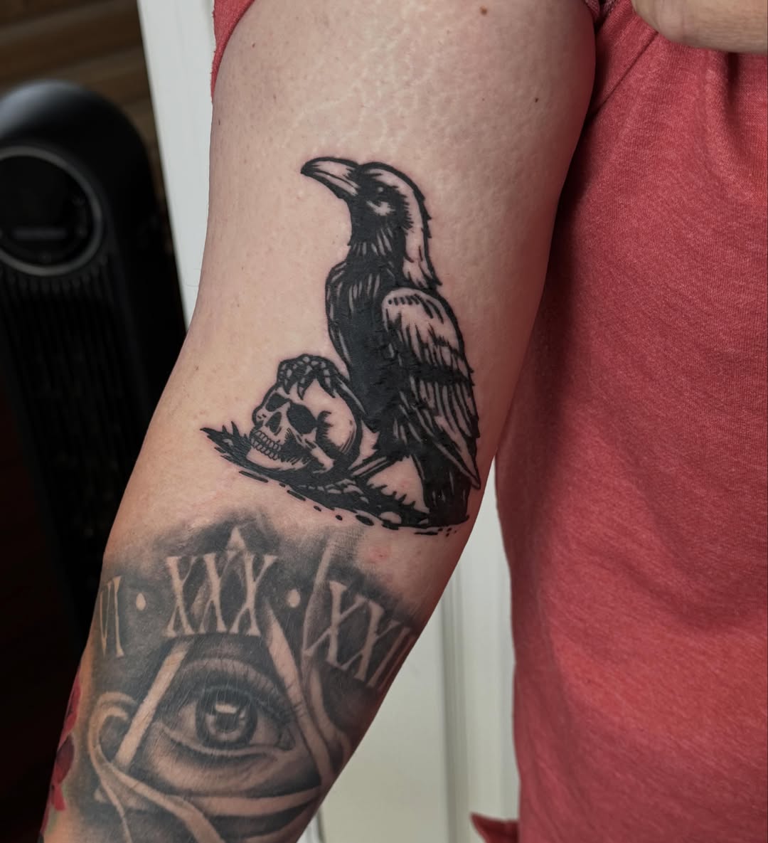Crow and skull black and grey tattoo on the forearm by Emma Mathis, Springfield, Oregon