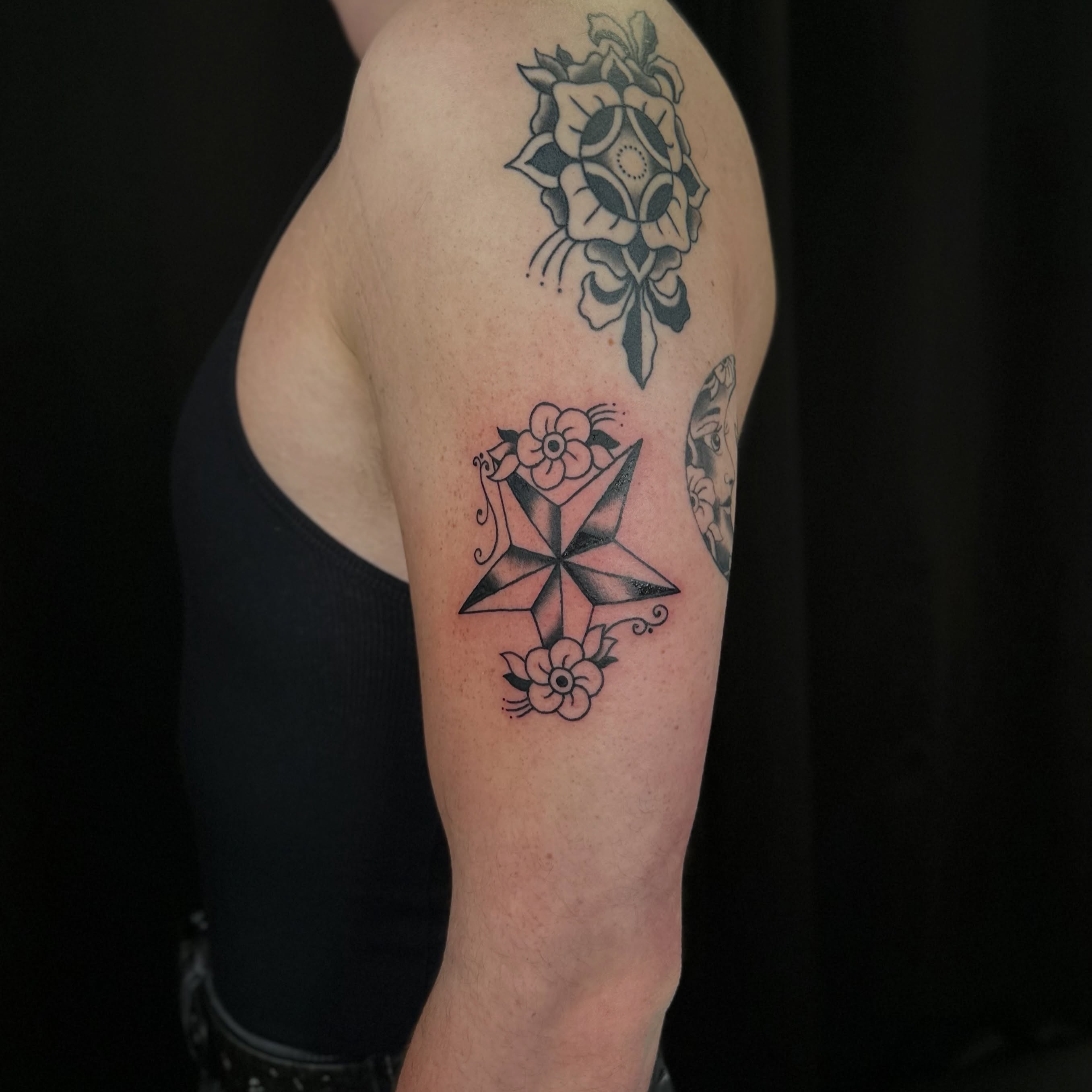 Geometric star with flowers geometric tattoo on the forearm by Tyyler Santor (Tattoo Artist), Somerville, Massachusetts