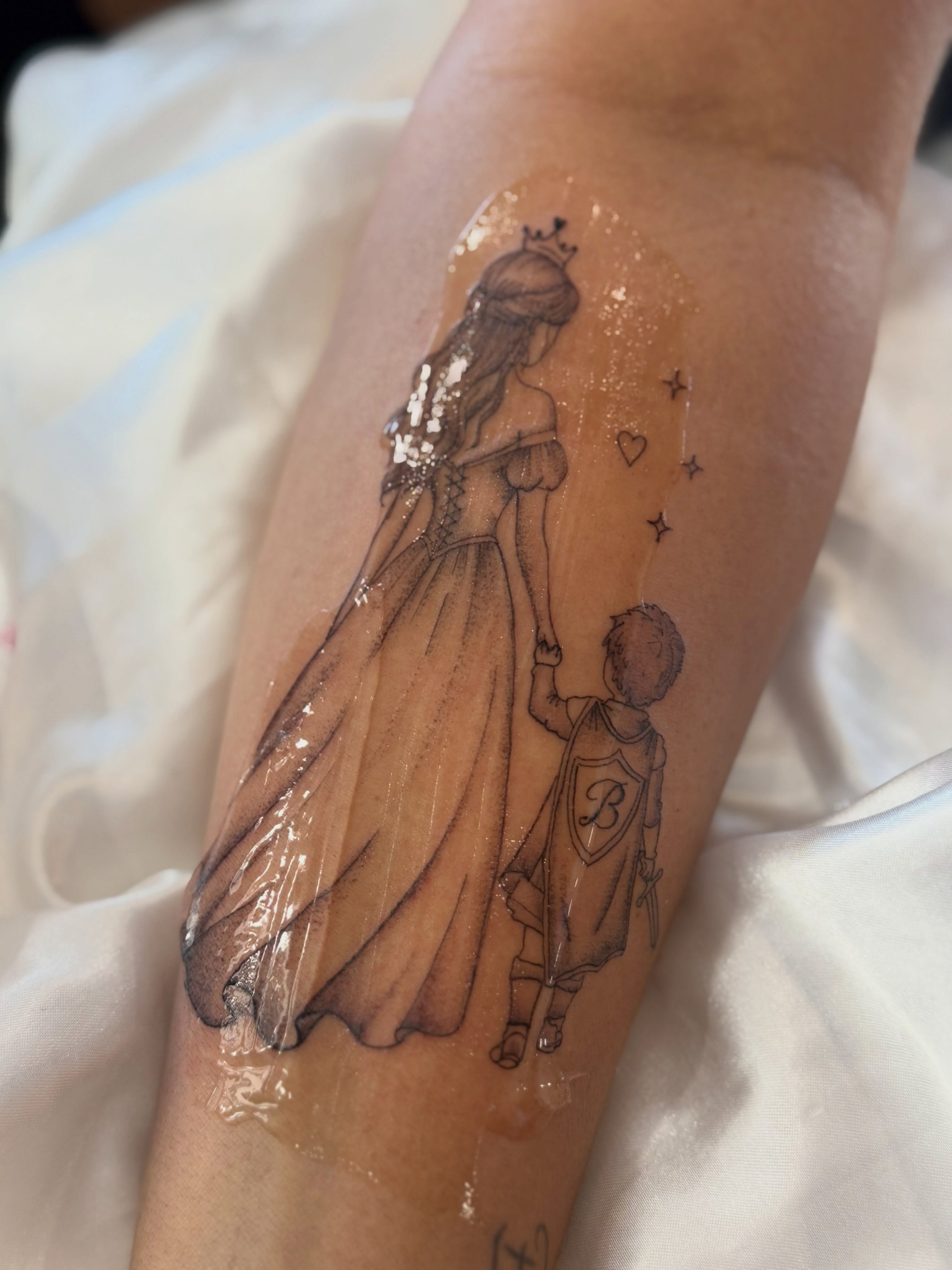 Royal couple realism tattoo on the forearm by Silva Wellen
