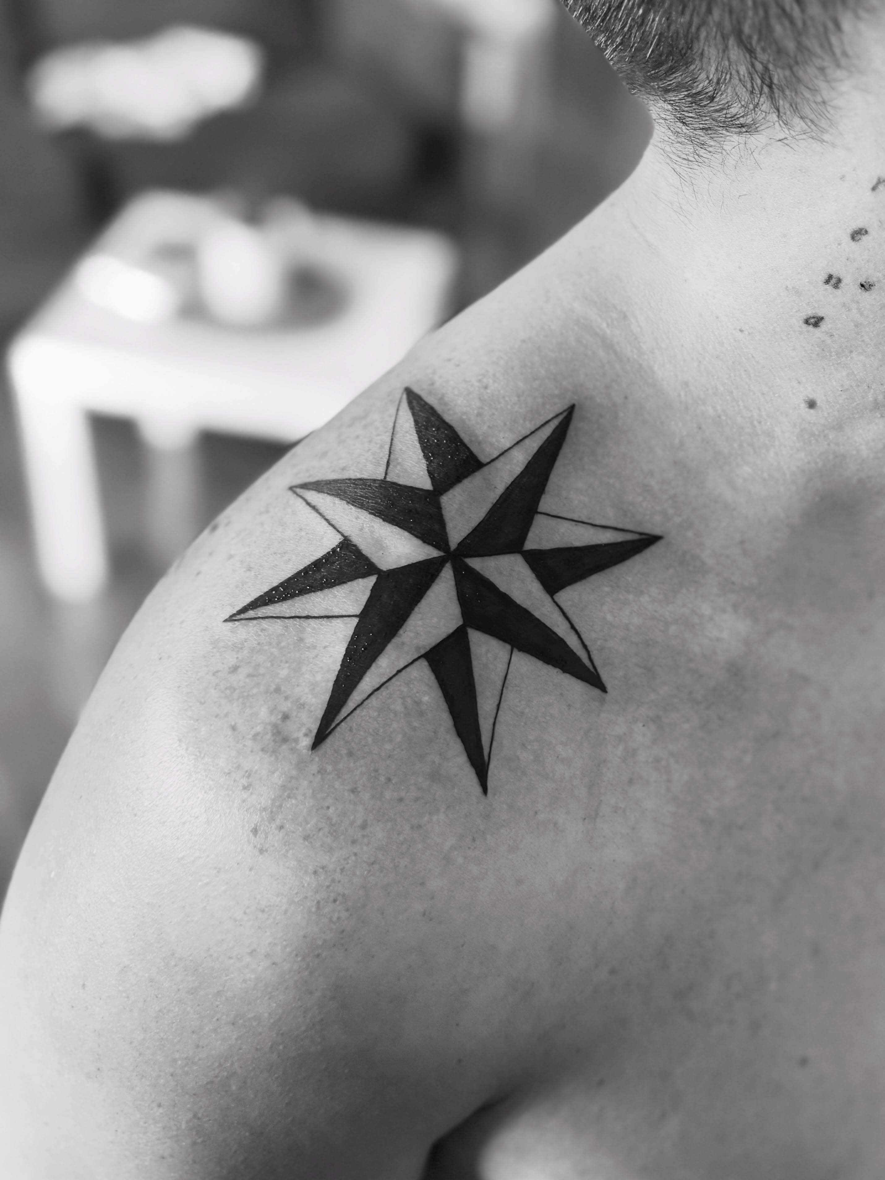 Nautical star geometric tattoo on the shoulder by @secretlinetattoo