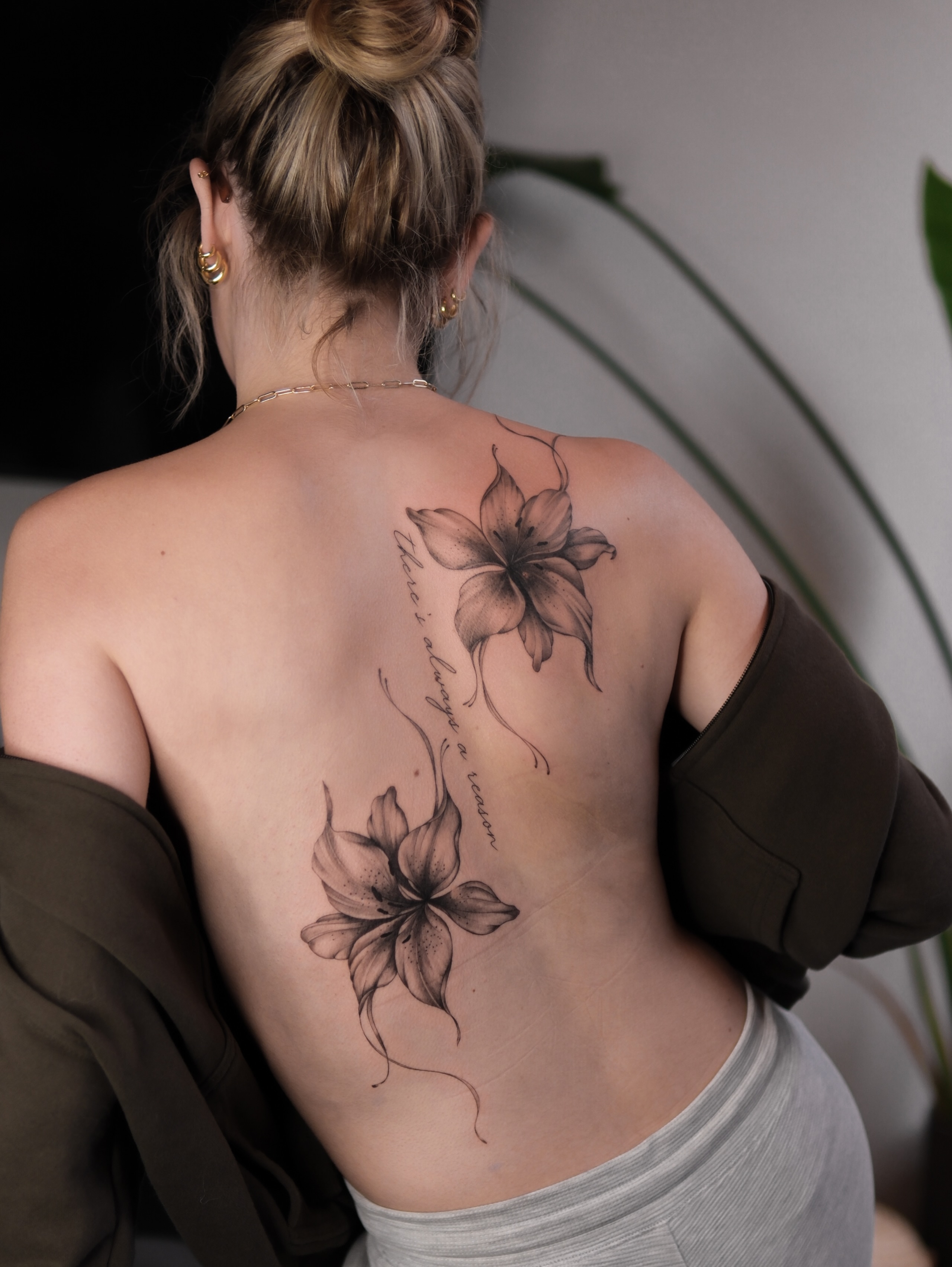 Lilies black and grey tattoo on the back by Alina 🌙 Tattoo in Calgary 🇨🇦