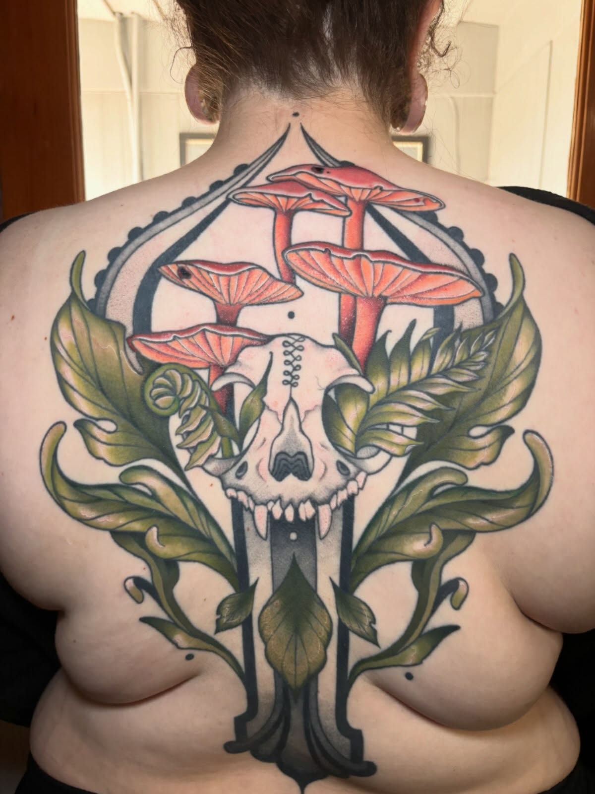 Skull and mushrooms neo-traditional tattoo on the back by Wren Hollow, Portland, Oregon