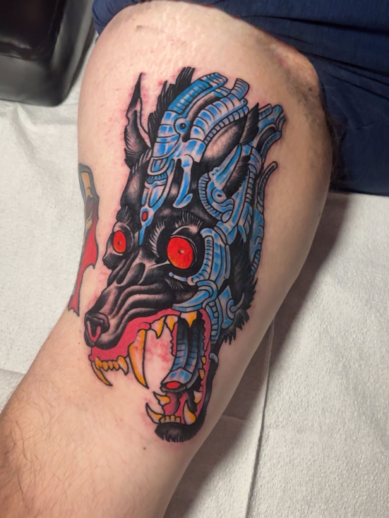 Cyborg wolf American traditional tattoo on the thigh by Chris Prince Jr., Miamisburg, Ohio