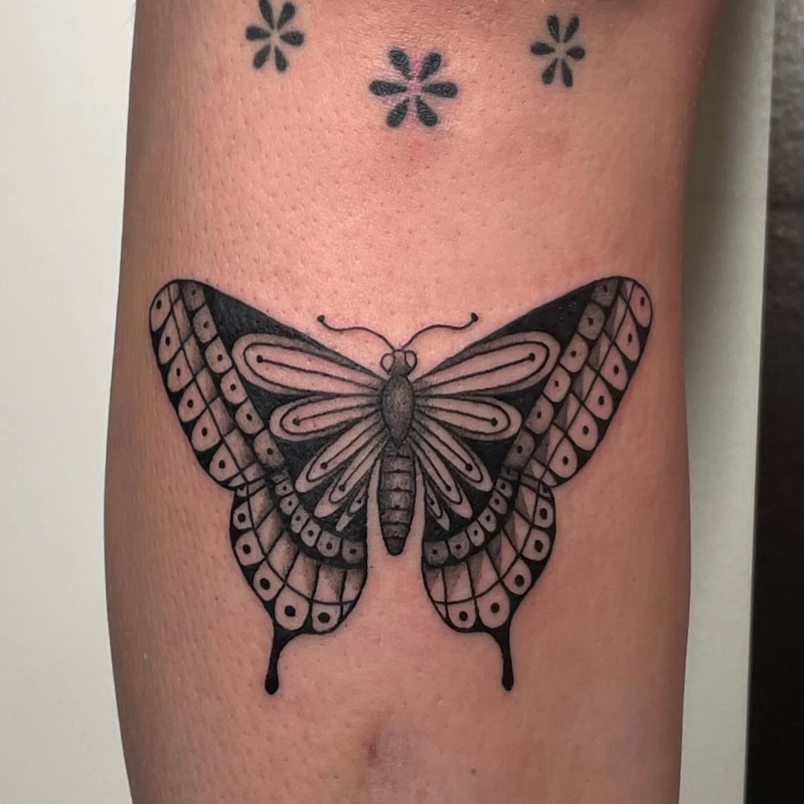 Butterfly black and grey tattoo on the forearm by Avalon Sable