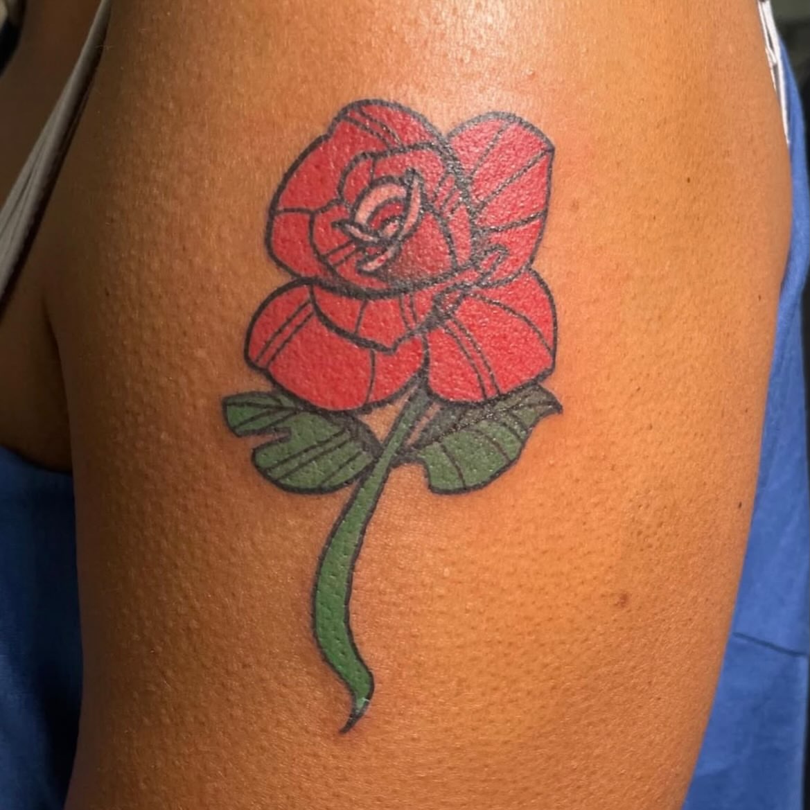 Red rose American traditional tattoo on the thigh by Avalon Sable