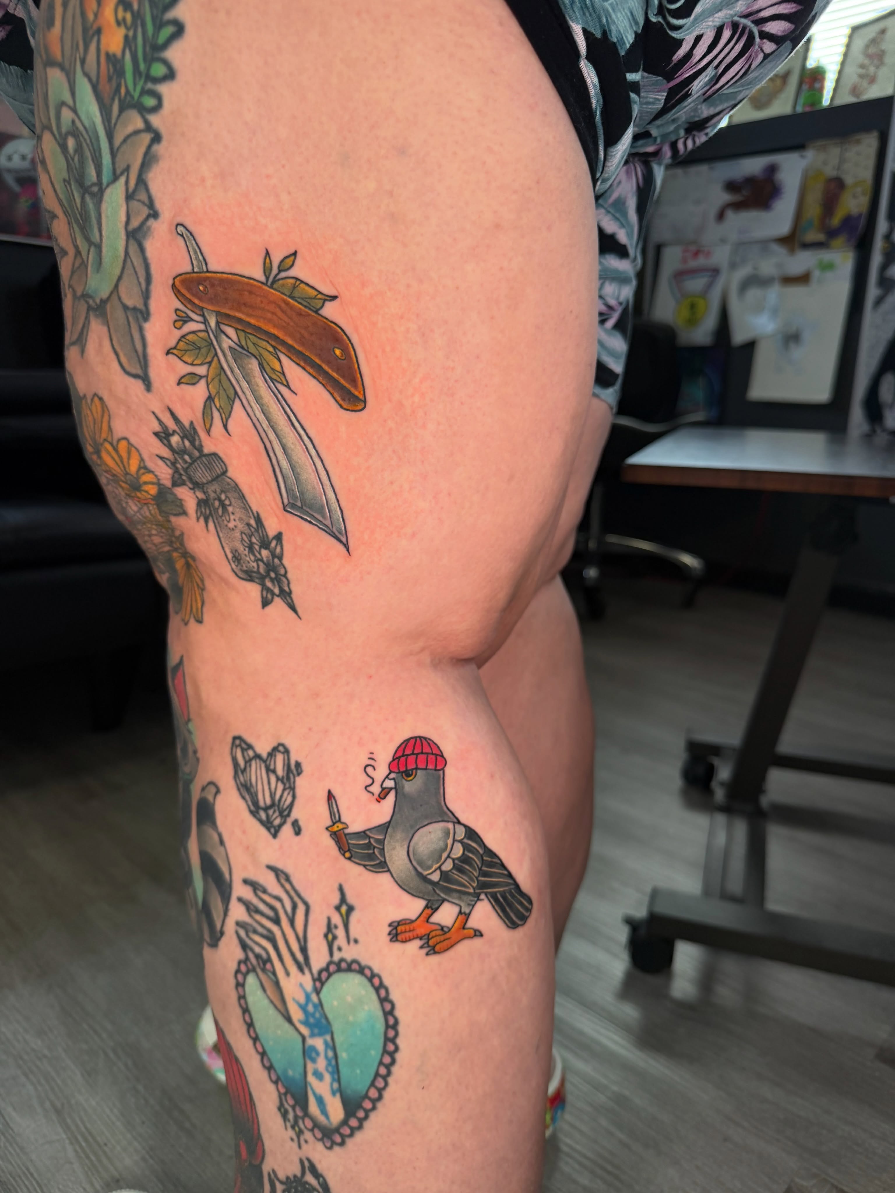 Bird wearing a hat American traditional tattoo on the thigh by Beau Zeis