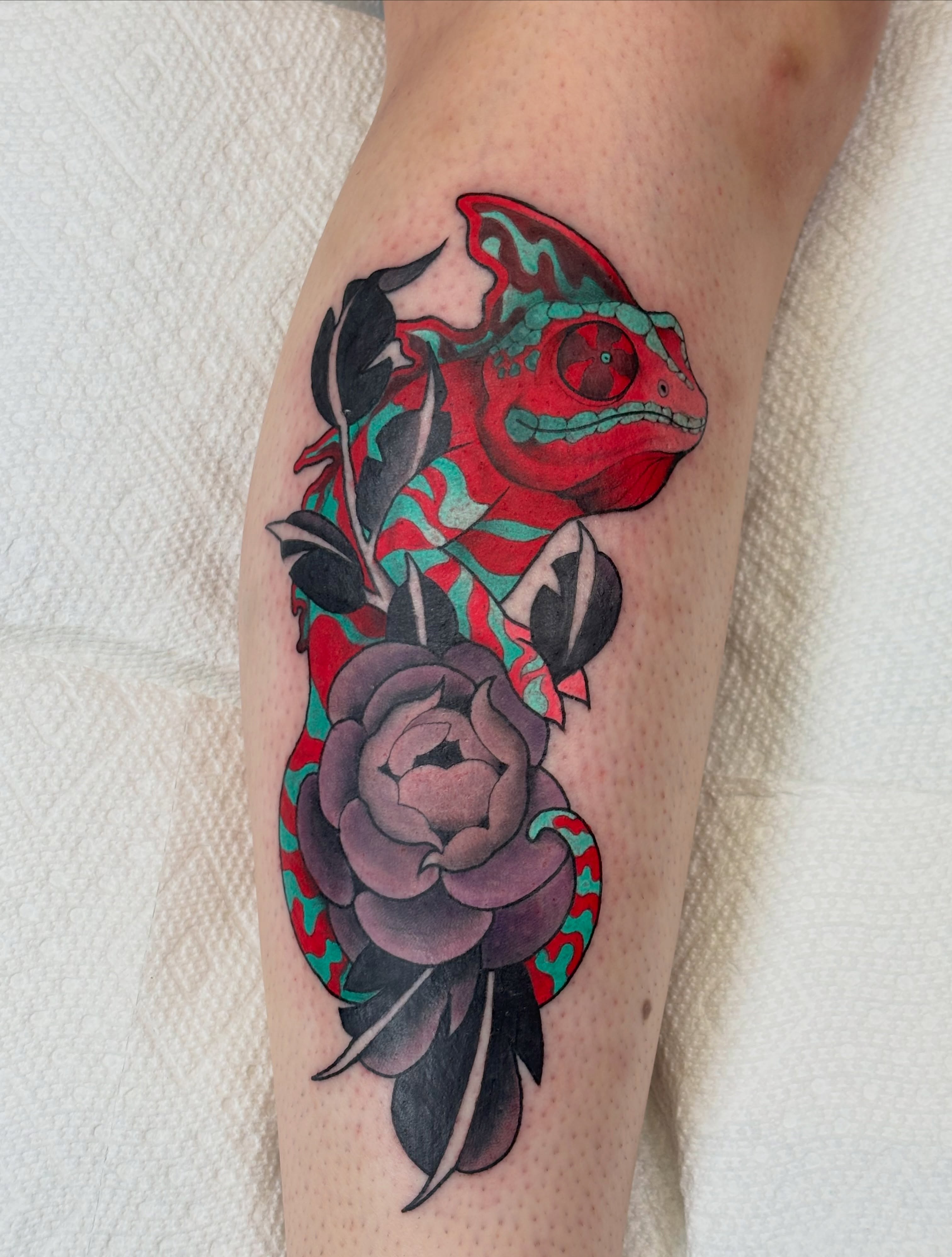 Chameleon and rose American traditional tattoo on the forearm by MJ Saunders