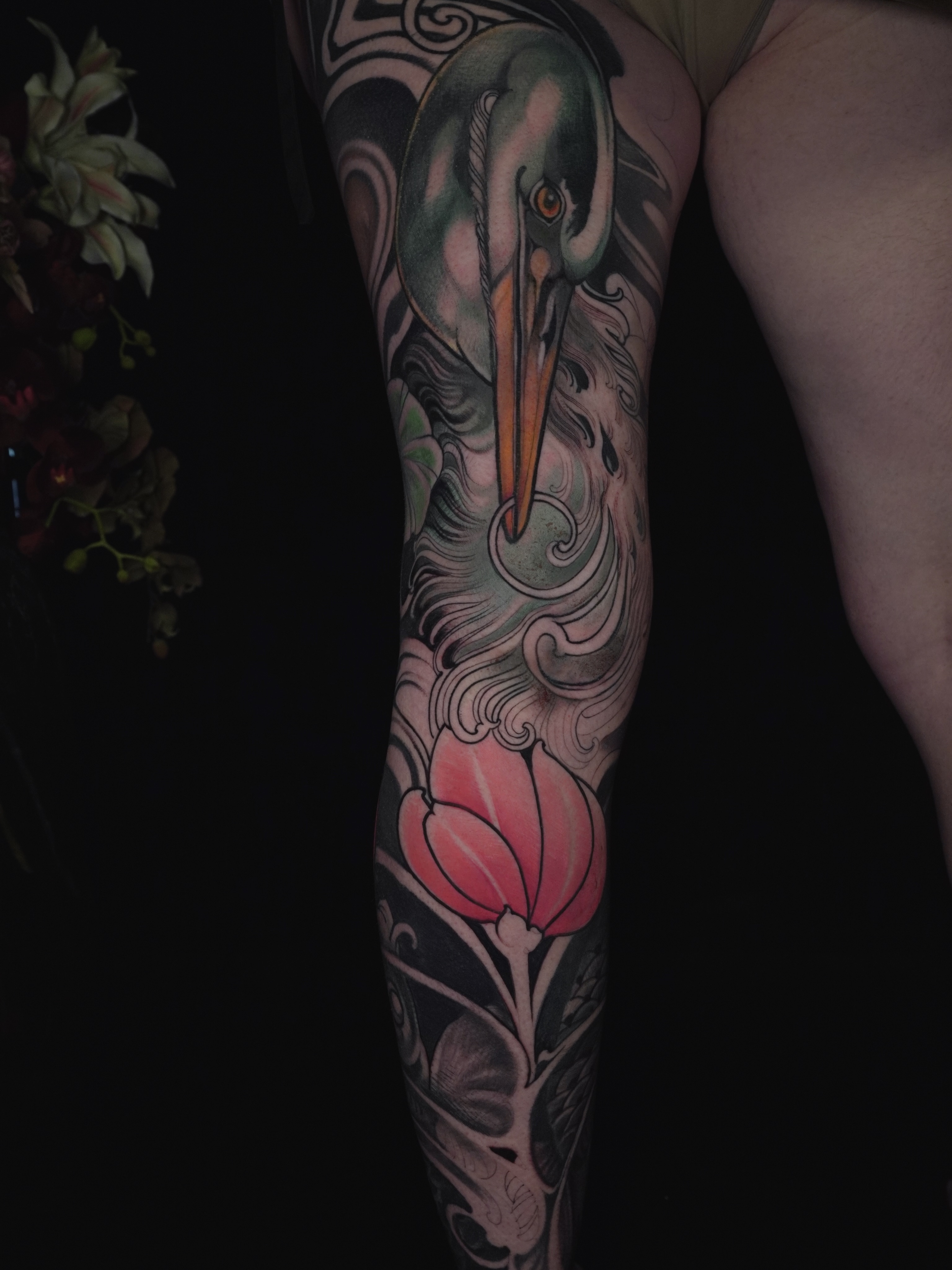 Heron and tulip American traditional tattoo on the forearm by Lorena Borges Gomes