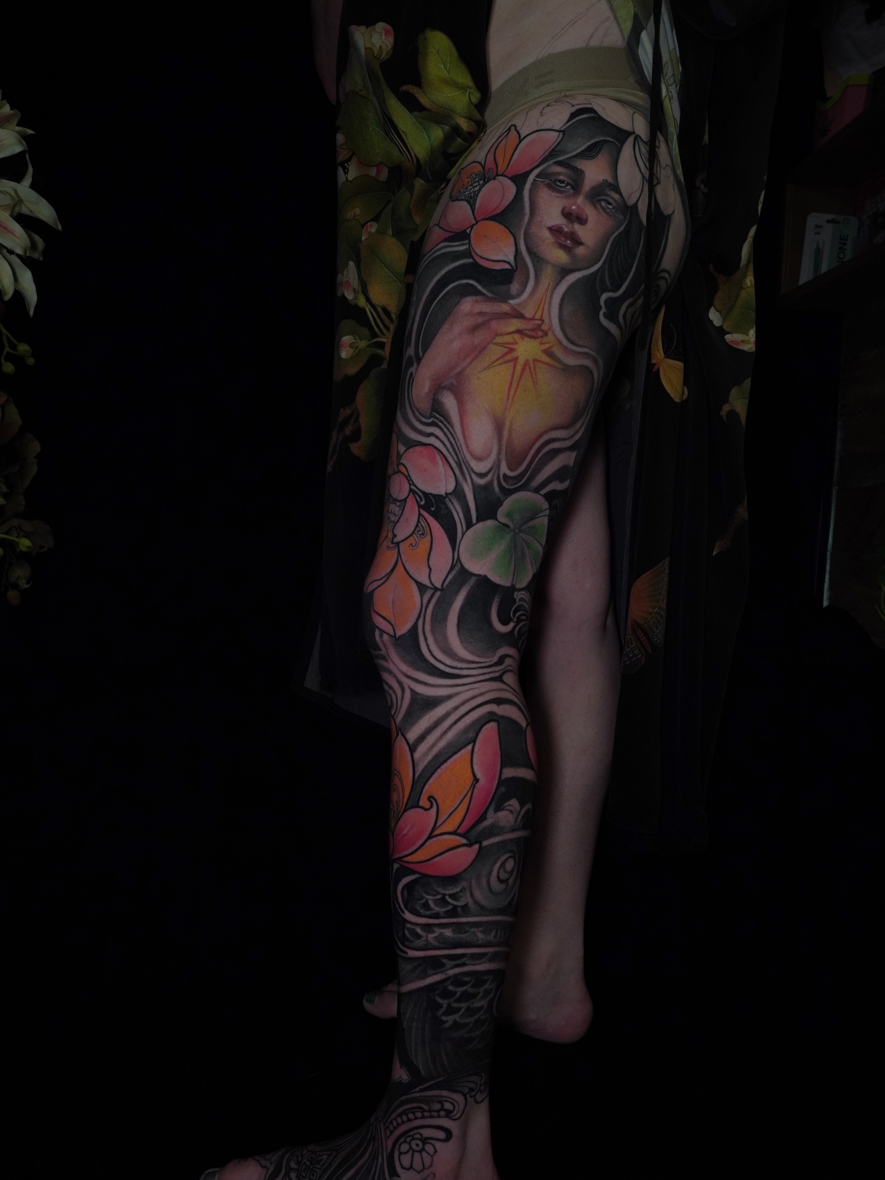 Woman with lotus flowers American traditional tattoo on the leg by Lorena Borges Gomes