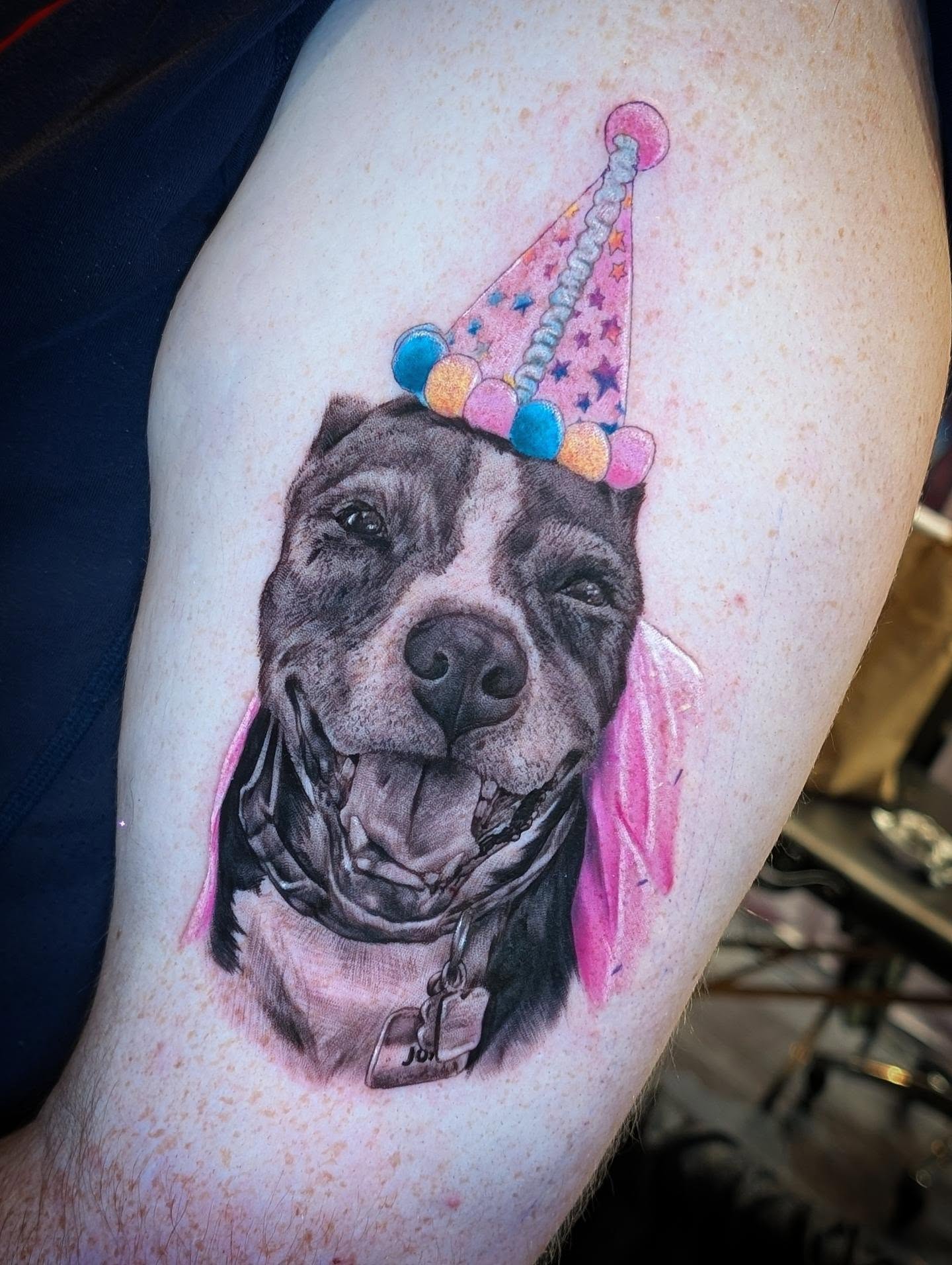 Pitbull wearing party hat realism tattoo on the thigh by Will Alexander, Lombard, Illinois