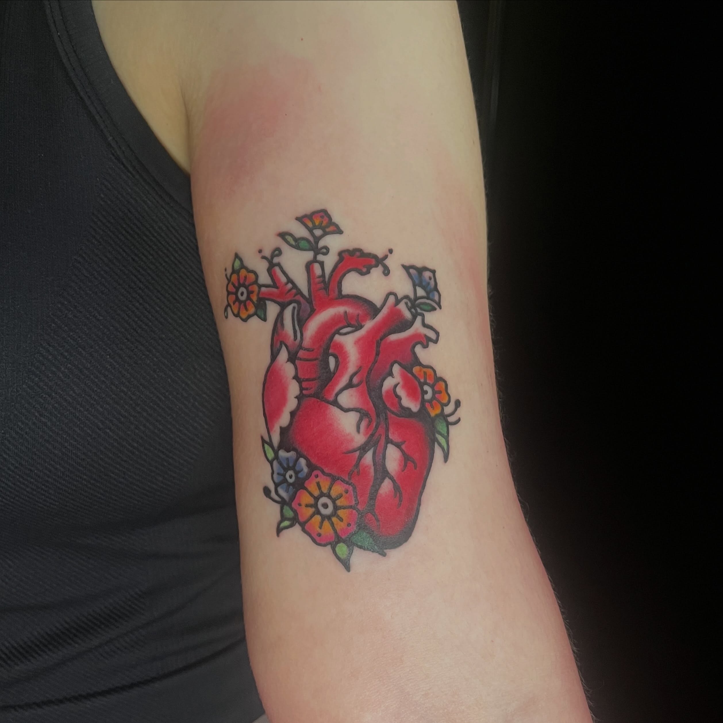 Heart with flowers American traditional tattoo on the forearm by madelynne (maddie) caldwell tattoos