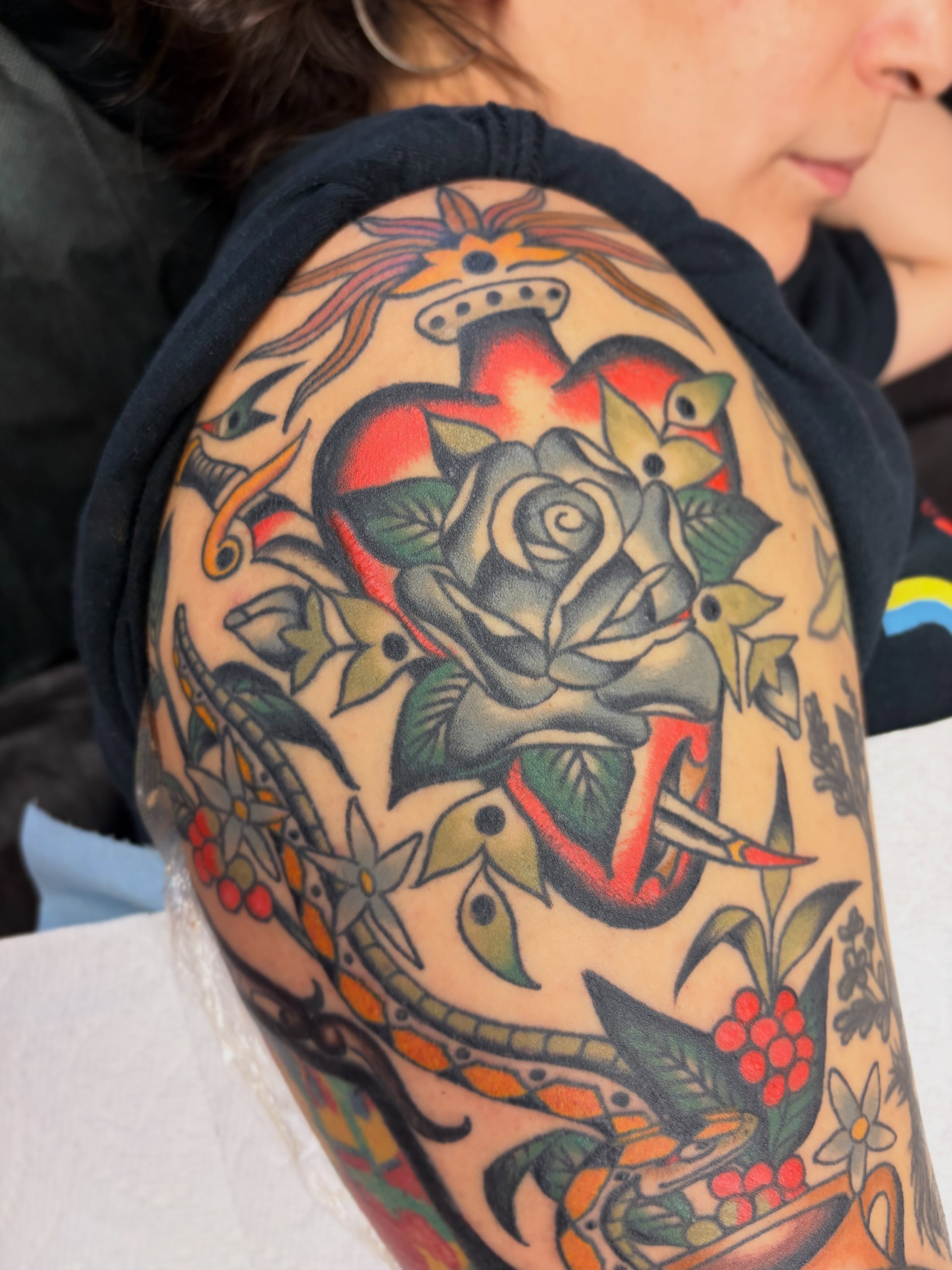 Rose and heart American traditional tattoo on the shoulder by Kelsey Lane