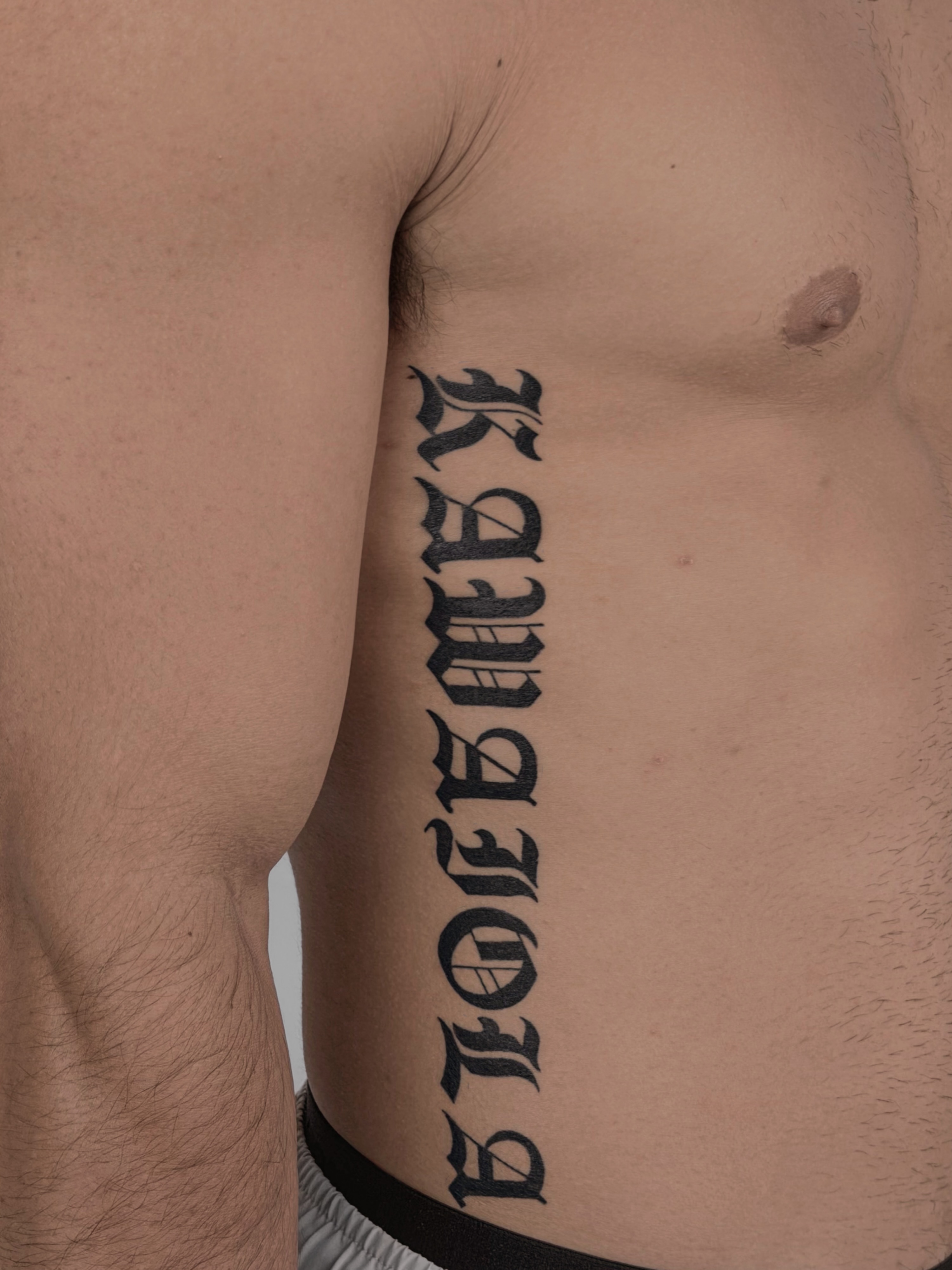 Kawabata lettering script tattoo on the ribs by Charlotte