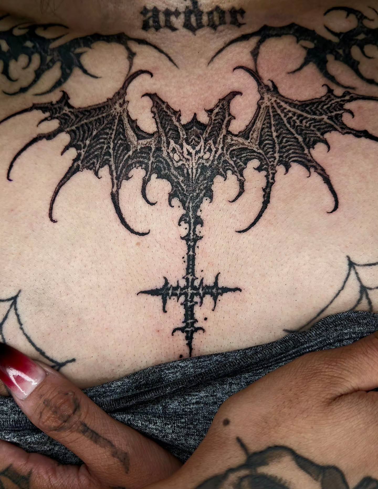 Bat geometric tattoo on the chest by @hellscribe