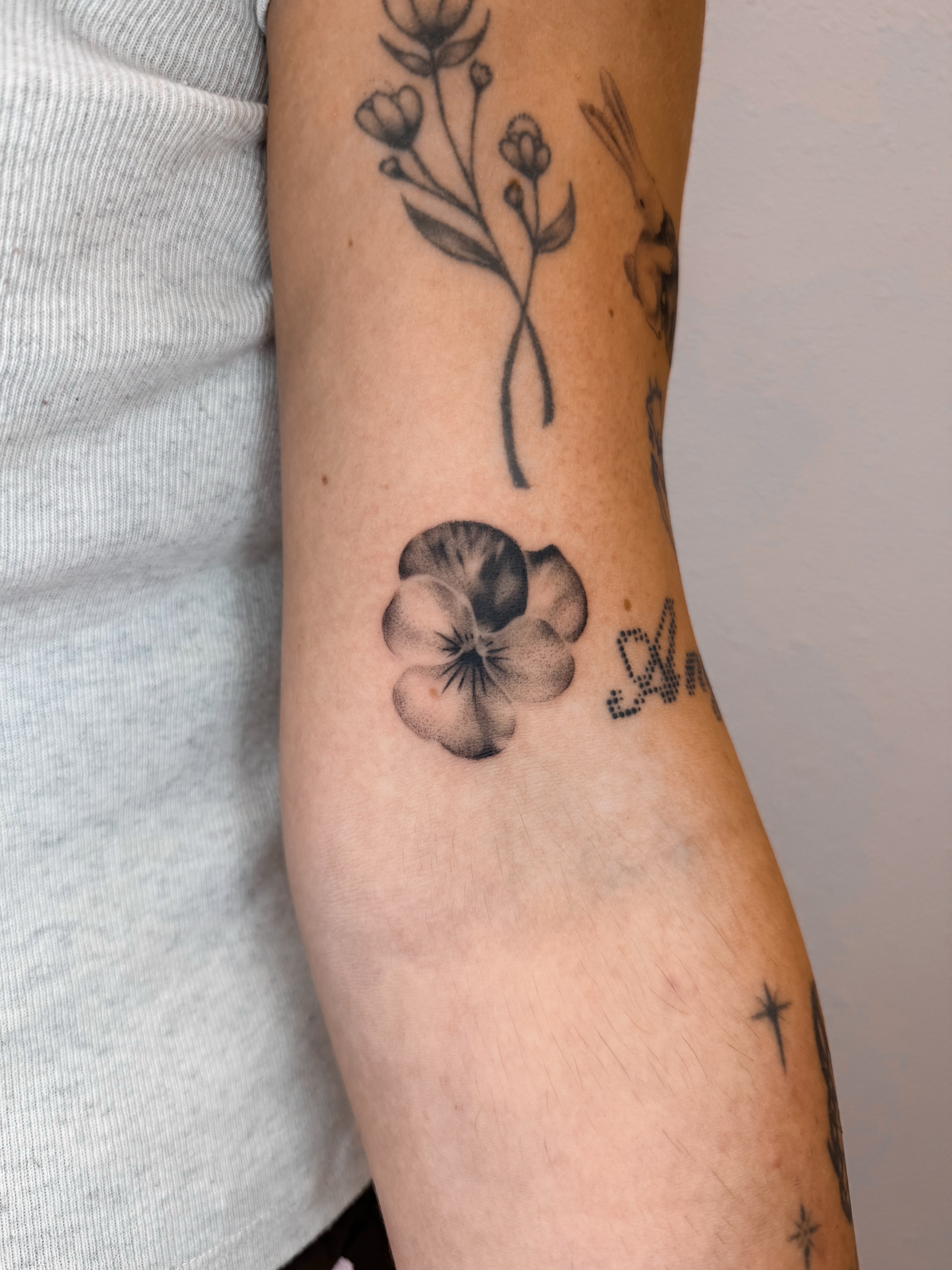 Flower dotwork tattoo on the forearm by Rylee