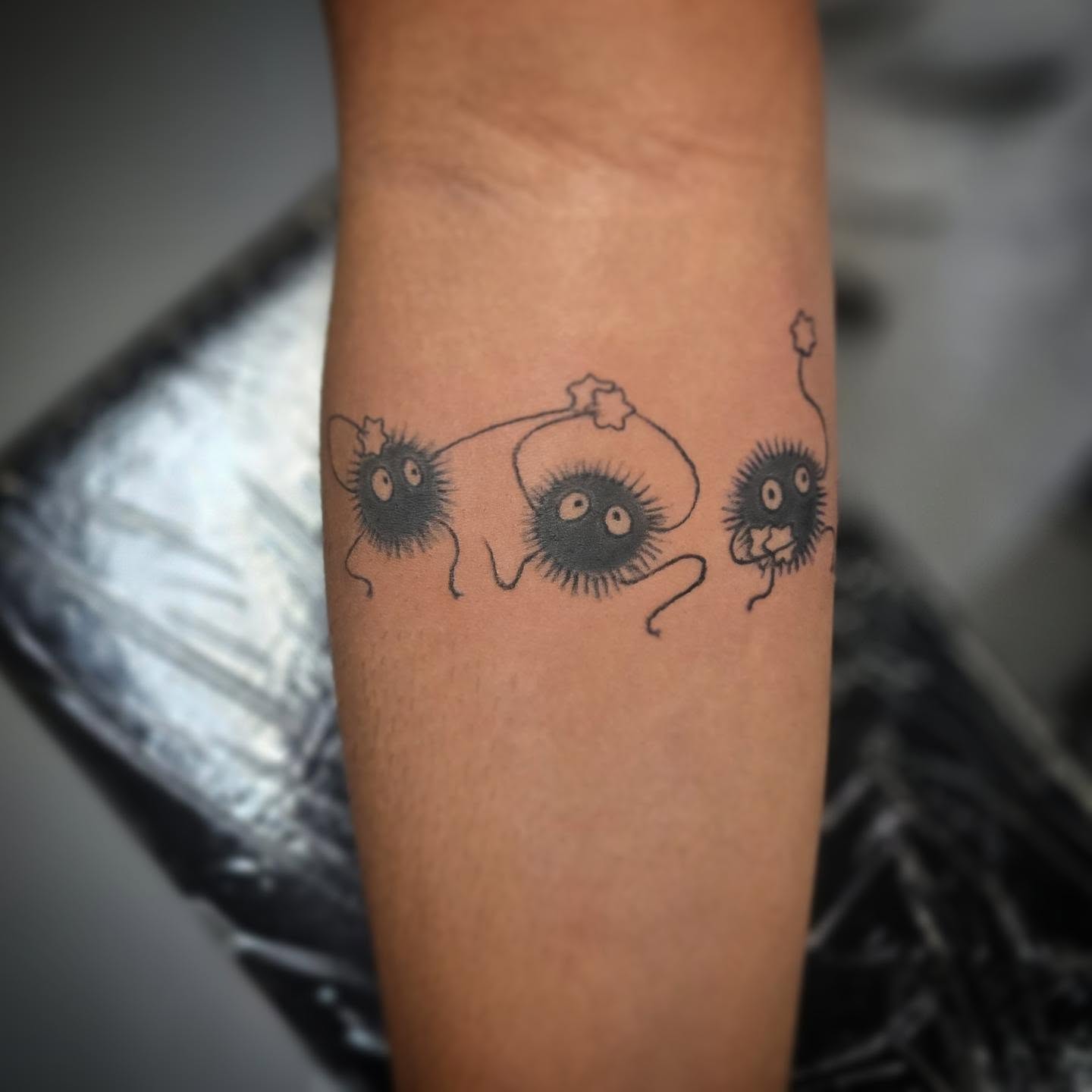 Three spiky creatures black and grey tattoo on the forearm by Anntonietta Borzacchiello