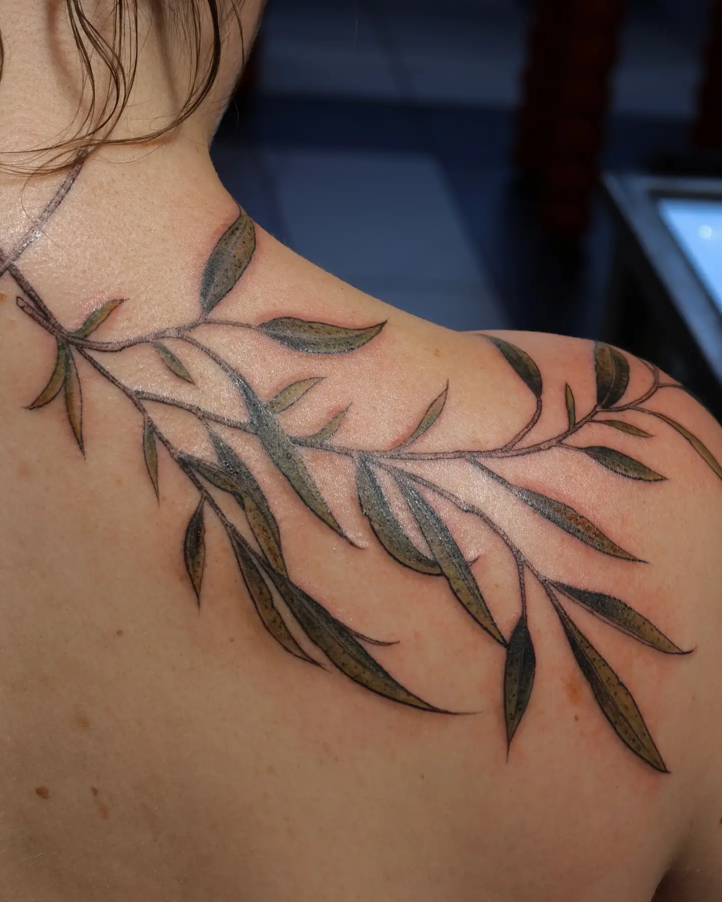 Branch with leaves black and grey tattoo on the shoulder by SF Tattoo Artist غريغوريو, San Francisco, California