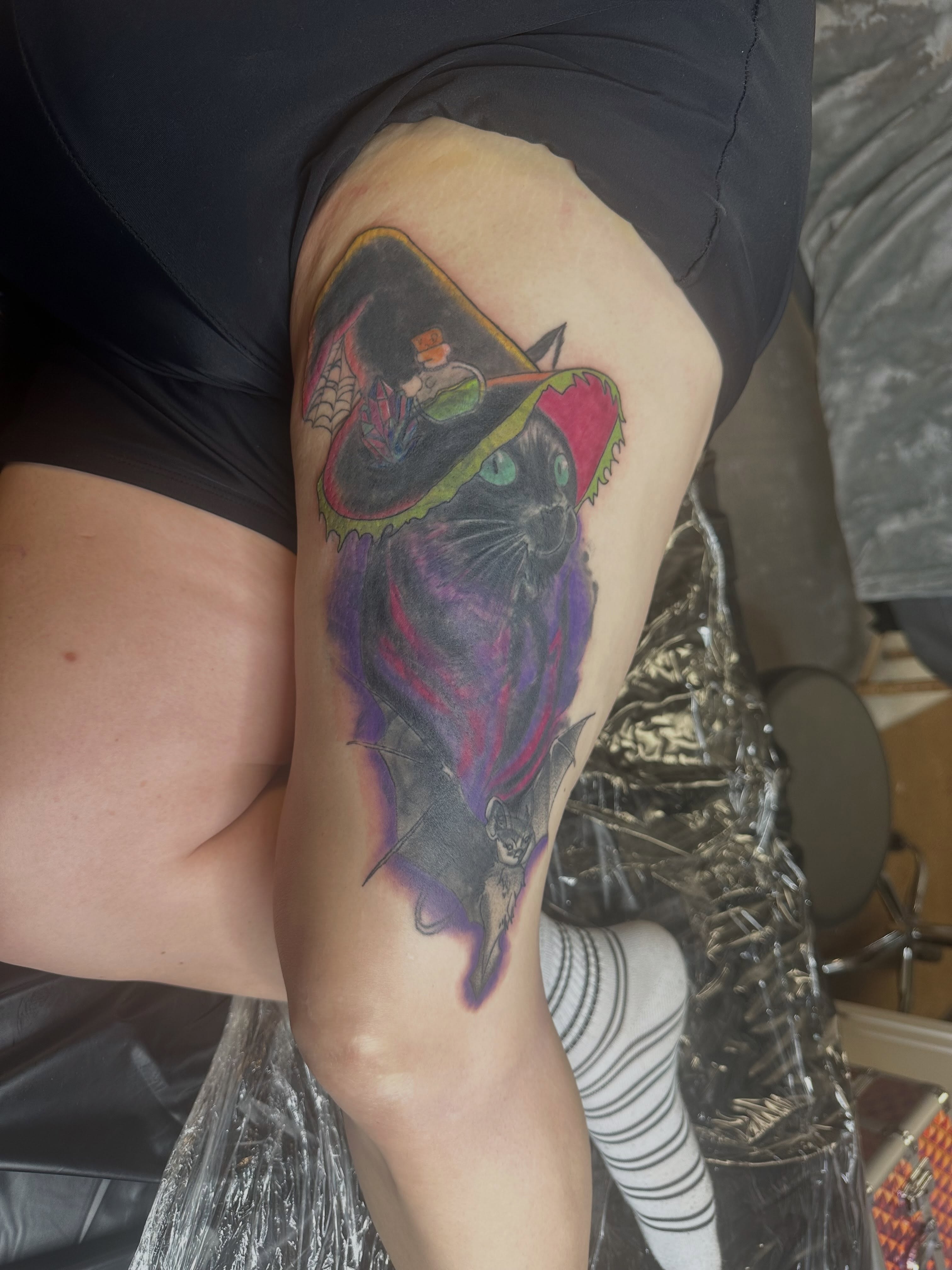 Cat and magician American traditional tattoo on the thigh by Rain David