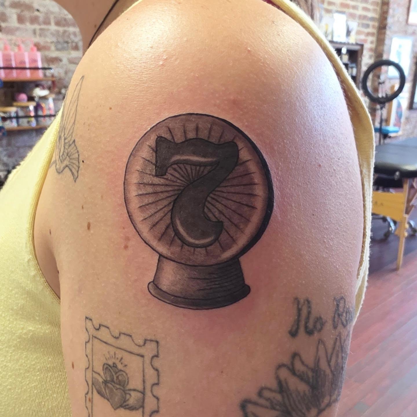 Number 7 black and grey tattoo on the shoulder by Tattoos by Annie