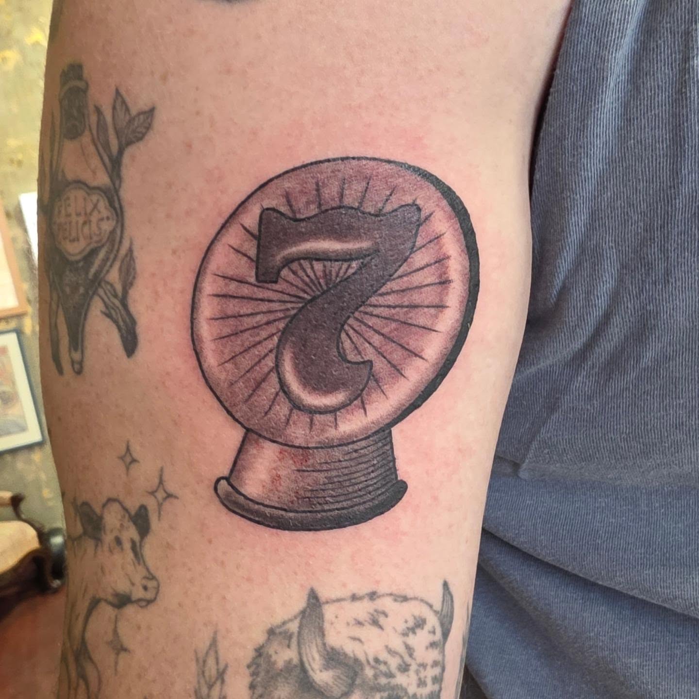 Ax in crystal ball black and grey tattoo on the forearm by Tattoos by Annie