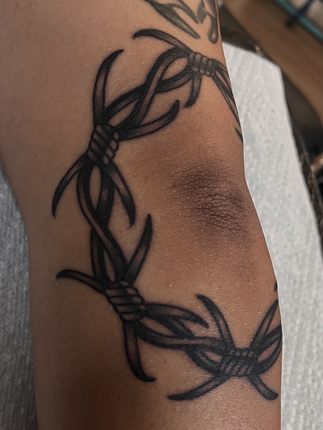Barbed wire black and grey tattoo on the forearm by Las Vegas Tattoo Artist