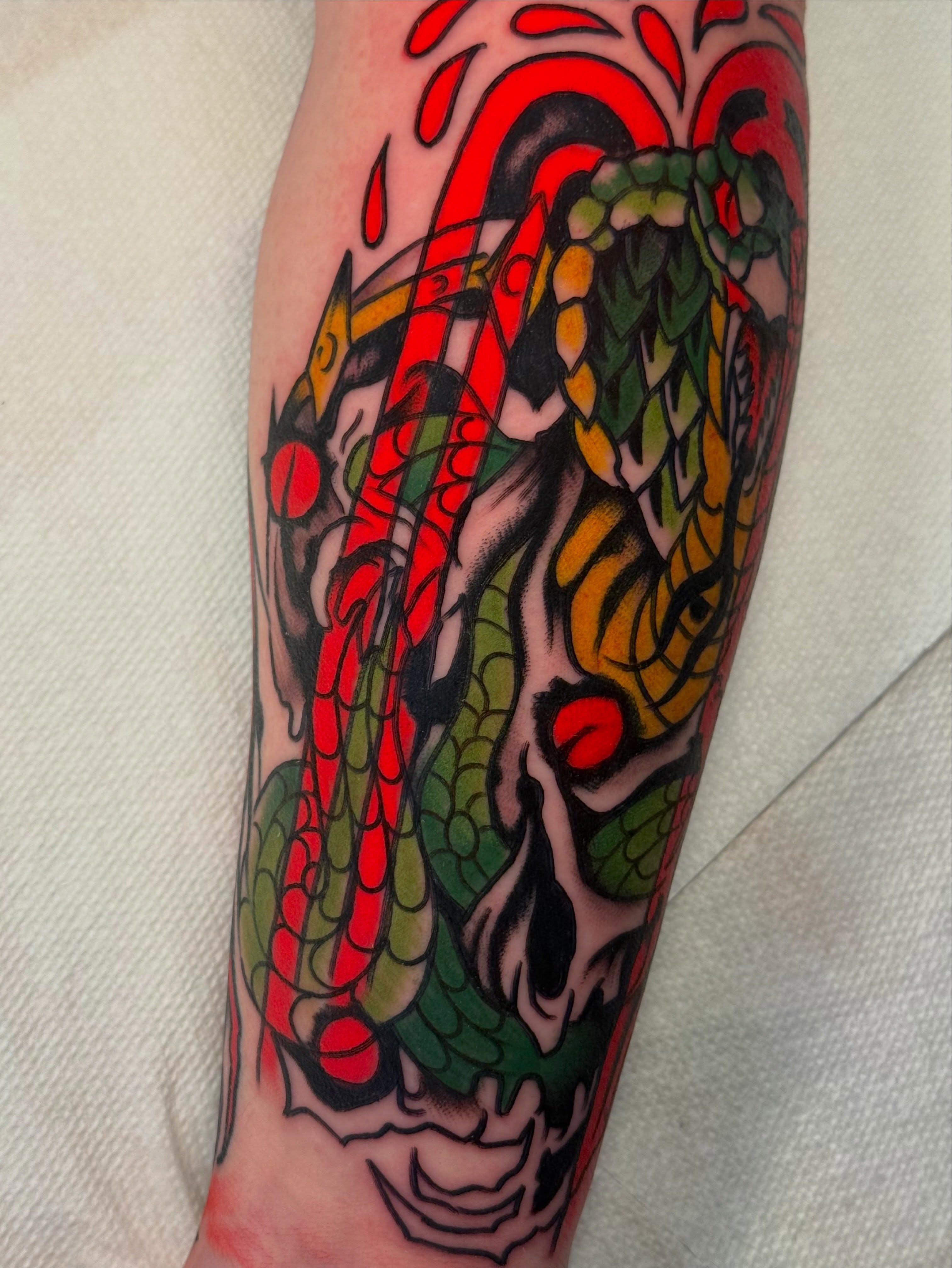 Dragon American traditional tattoo on the forearm by sydtatz