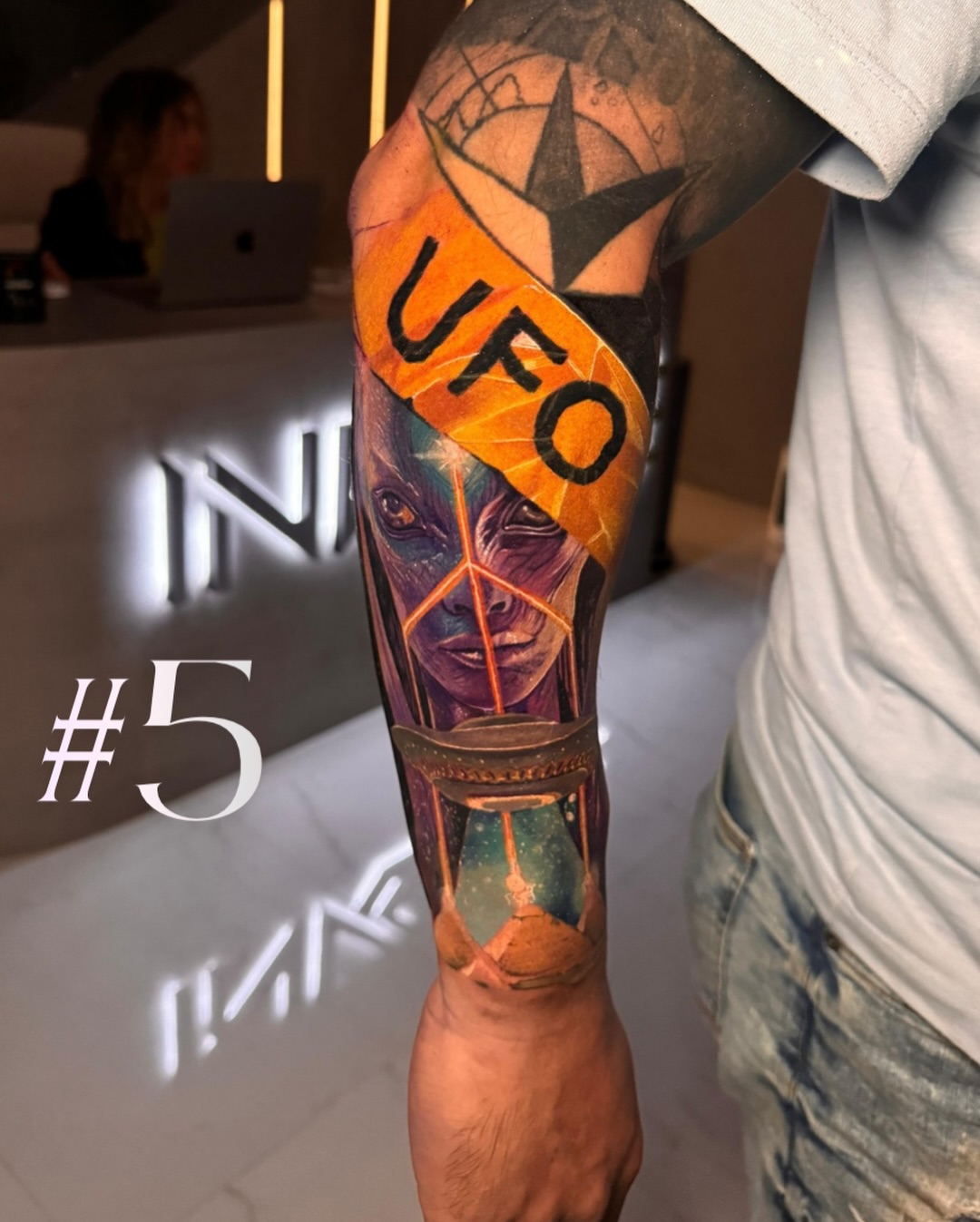Alien face realism tattoo on the forearm by Davier Del Castillo