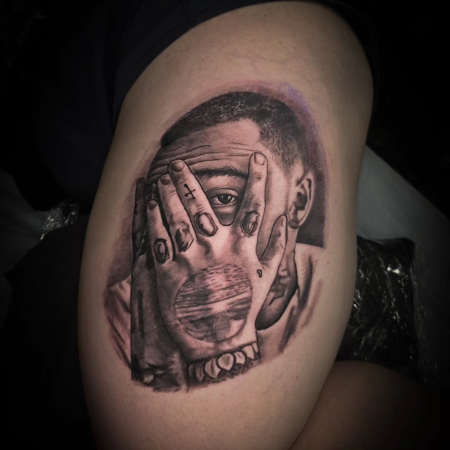 Hands covering face realism tattoo on the thigh by John Christo Blake