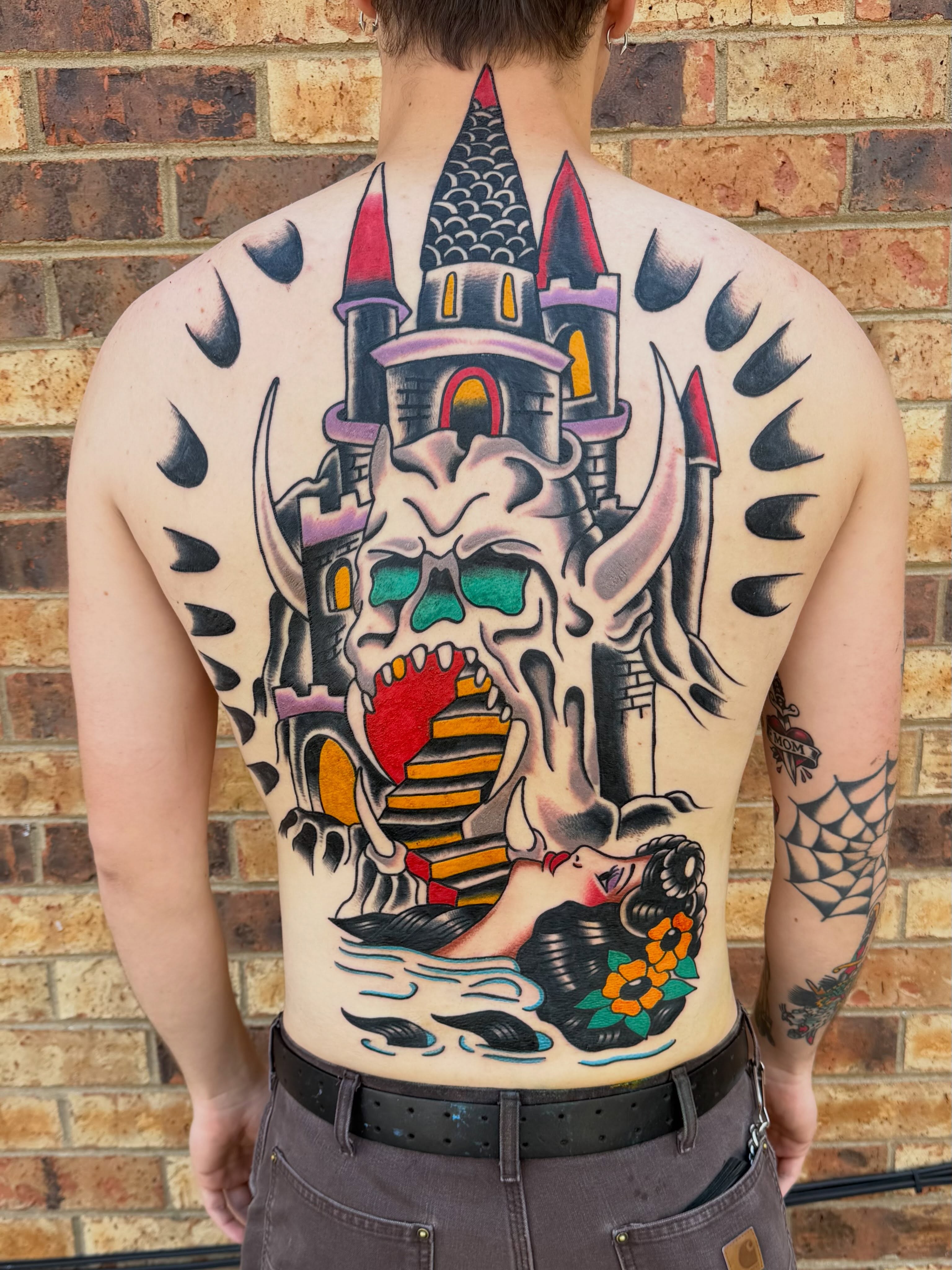 Castle and skull American traditional tattoo on the back by Don Lee